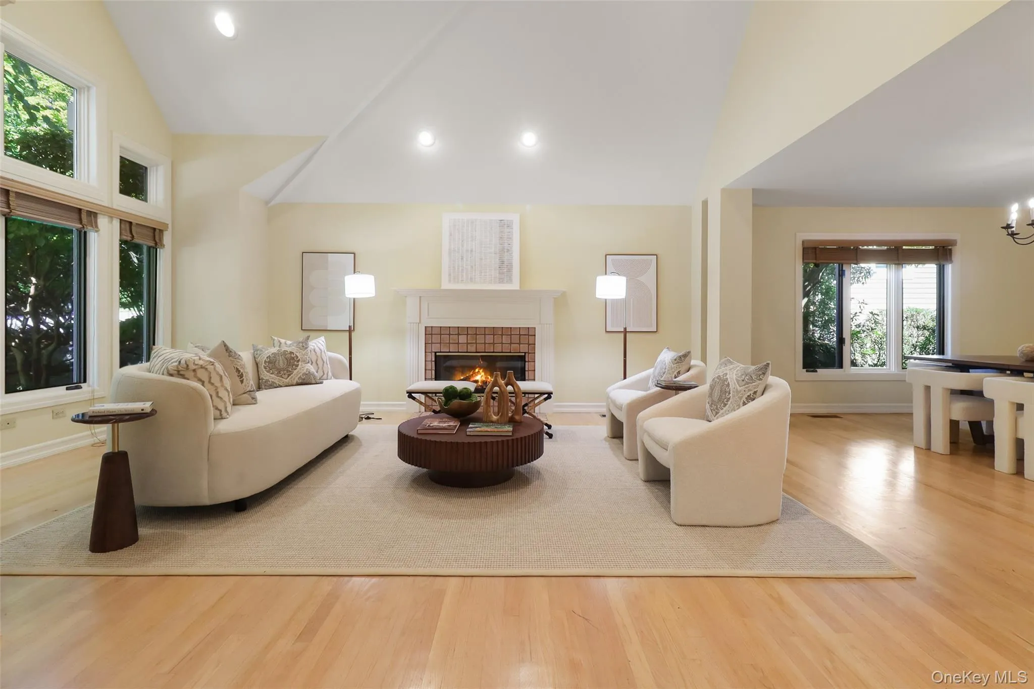 Spacious living room with vaulted ceiling and wood burning fireplace Spacious living room with vaulted ceiling and wood burning fireplace