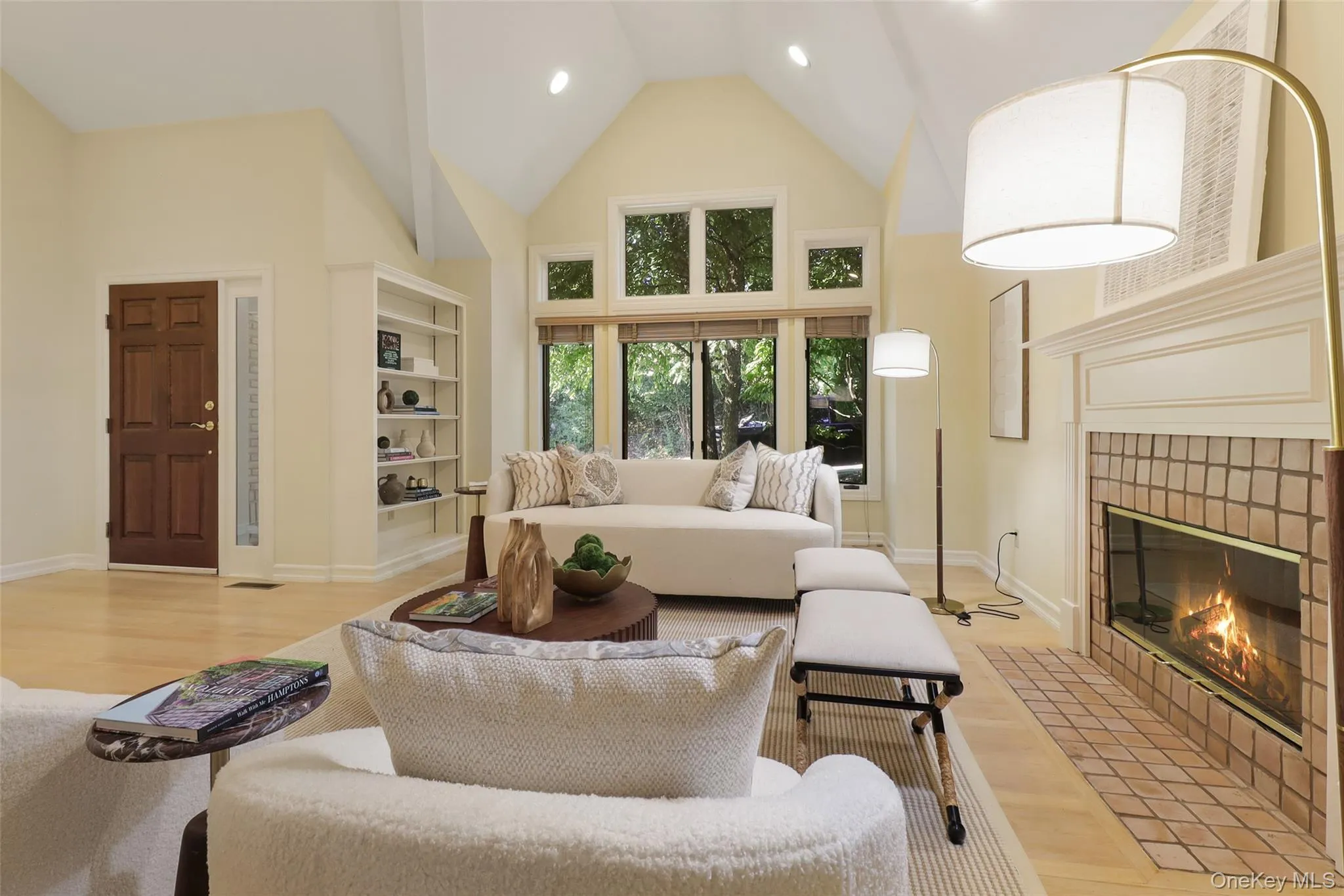 Spacious living room with vaulted ceiling and wood burning fireplace Spacious living room with vaulted ceiling and wood burning fireplace
