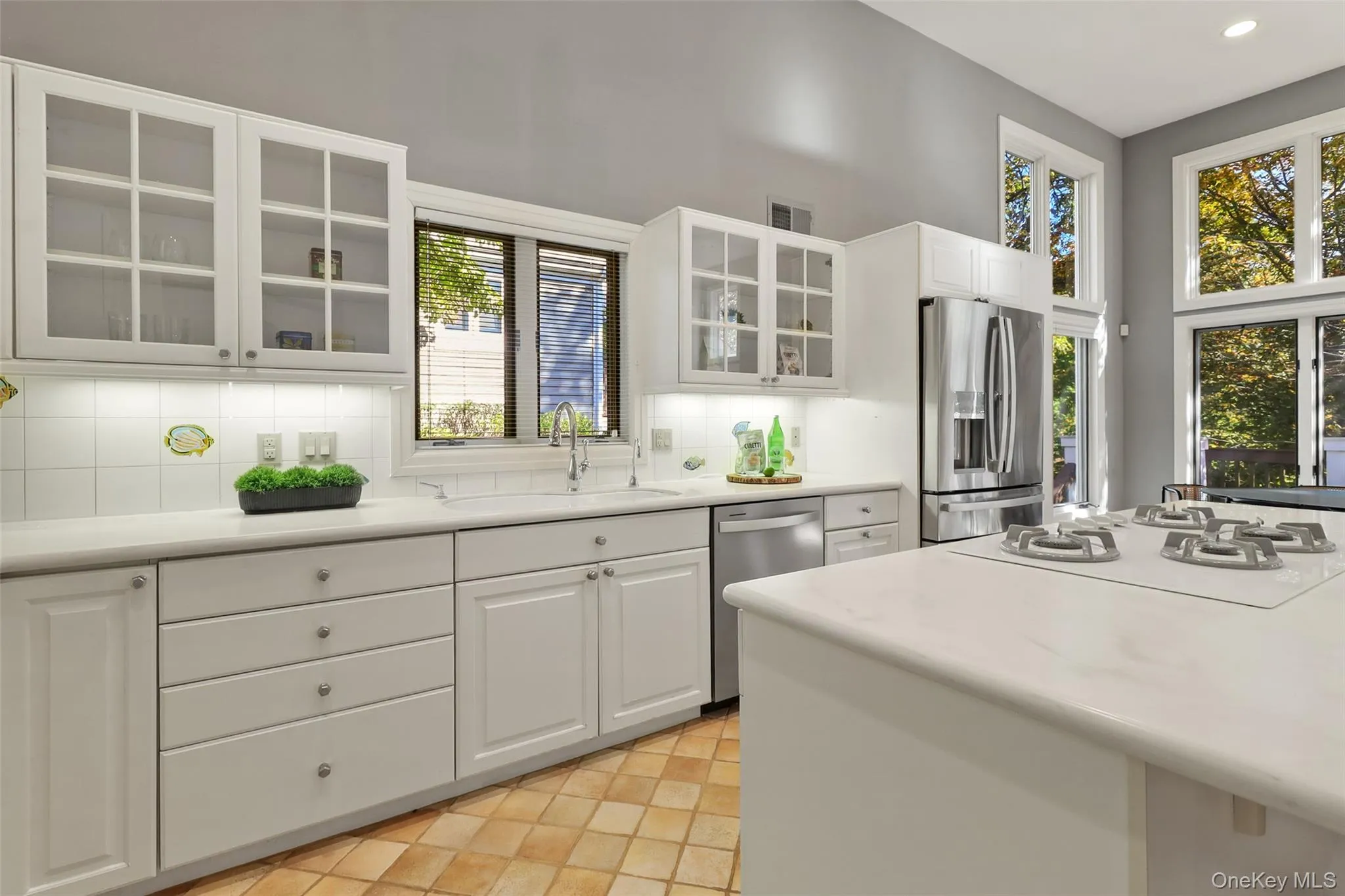 Kitchen, eat in kitchen, and family room with high ceilings and floor to ceiling windows Kitchen, eat in kitchen, and family room with high ceilings and floor to ceiling windows