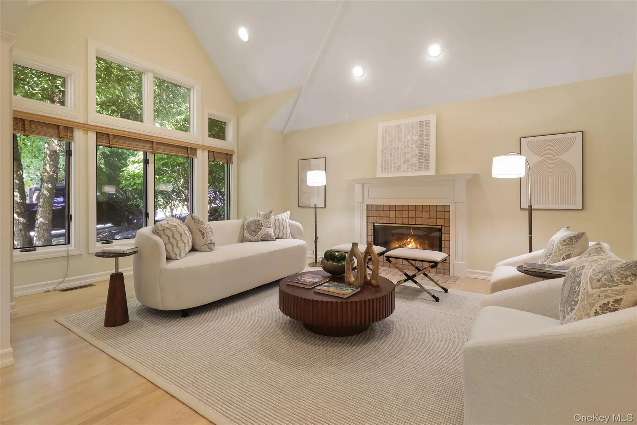 Spacious living room with vaulted ceiling and wood burning fireplace Spacious living room with vaulted ceiling and wood burning fireplace