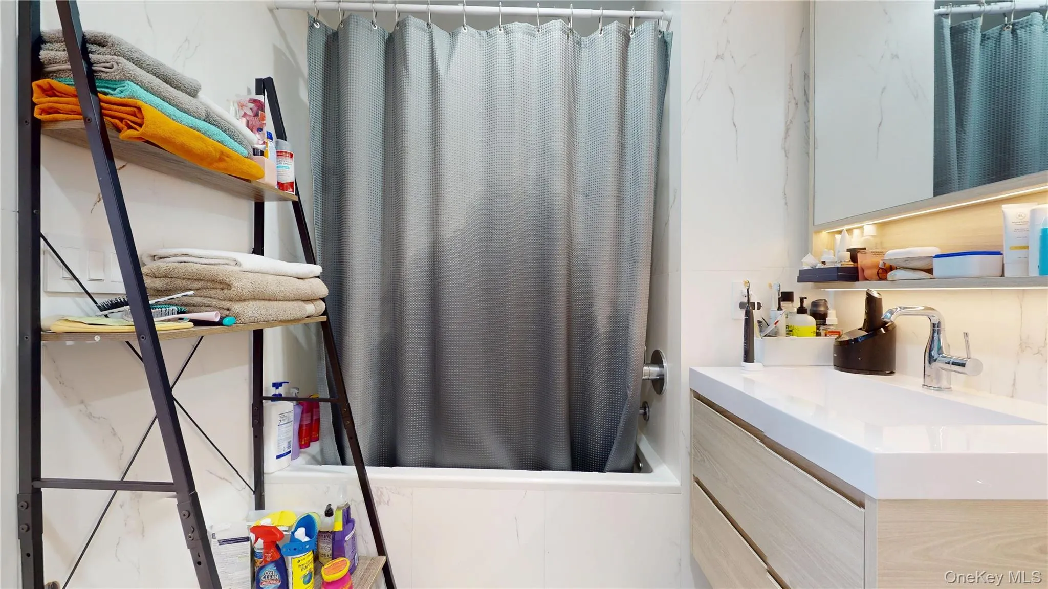 Bathroom featuring vanity and shower / bath combo with shower curtain Bathroom featuring vanity and shower / bath combo with shower curtain