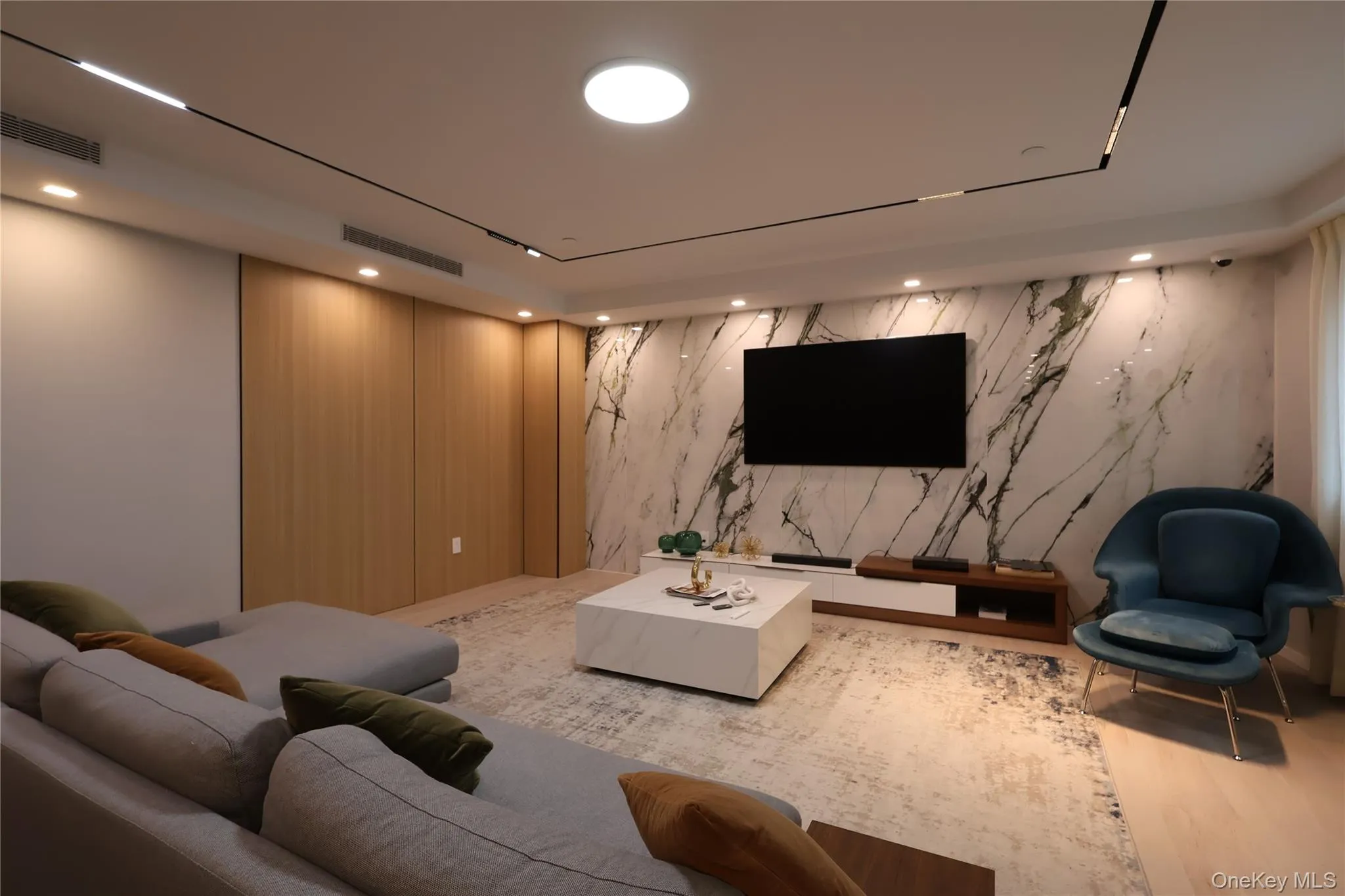 Living area featuring wallpapered walls and recessed lighting Living area featuring wallpapered walls and recessed lighting