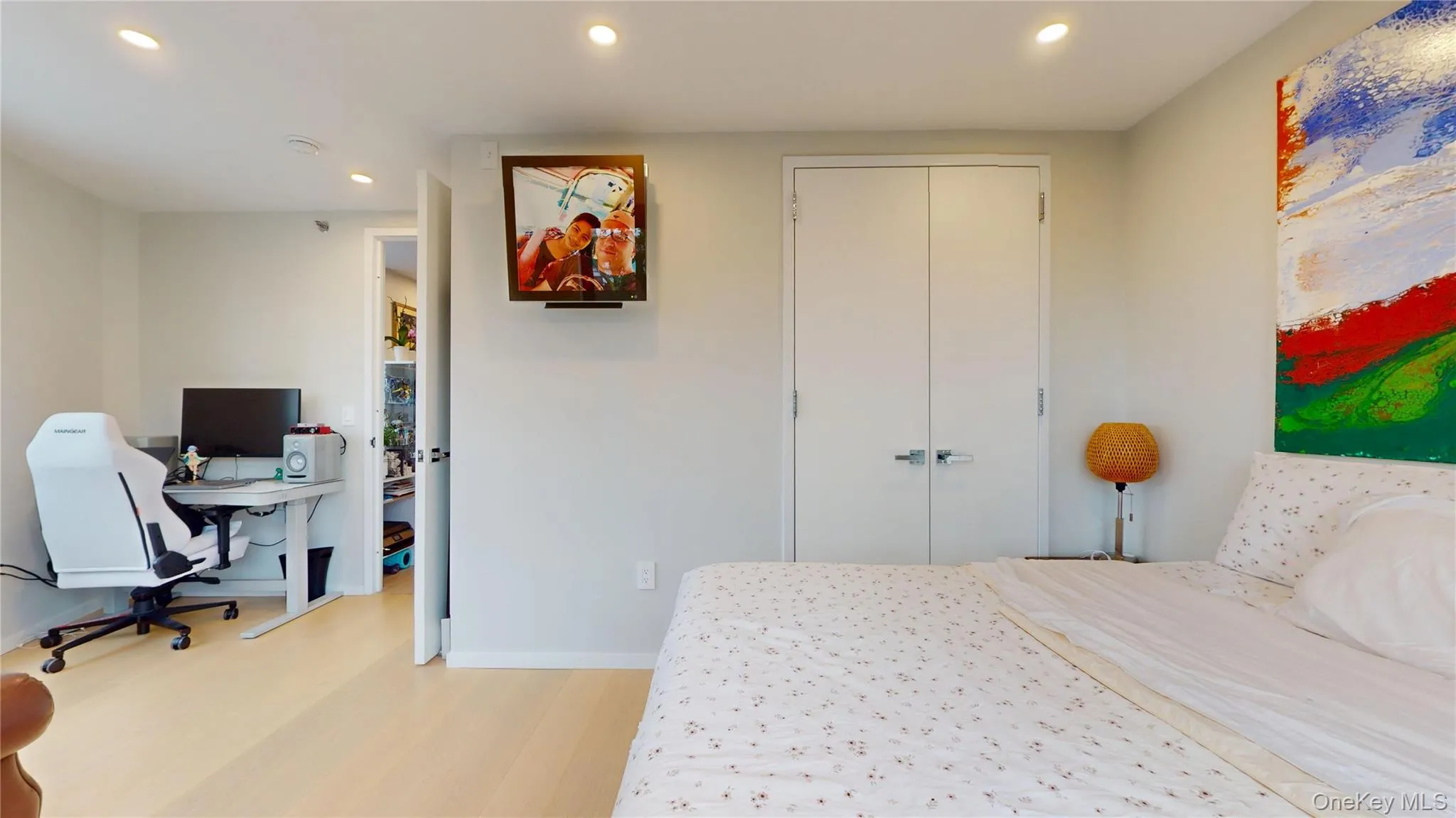 Bedroom featuring recessed lighting, light wood-style floors, baseboards, and a closet Bedroom featuring recessed lighting, light wood-style floors, baseboards, and a closet