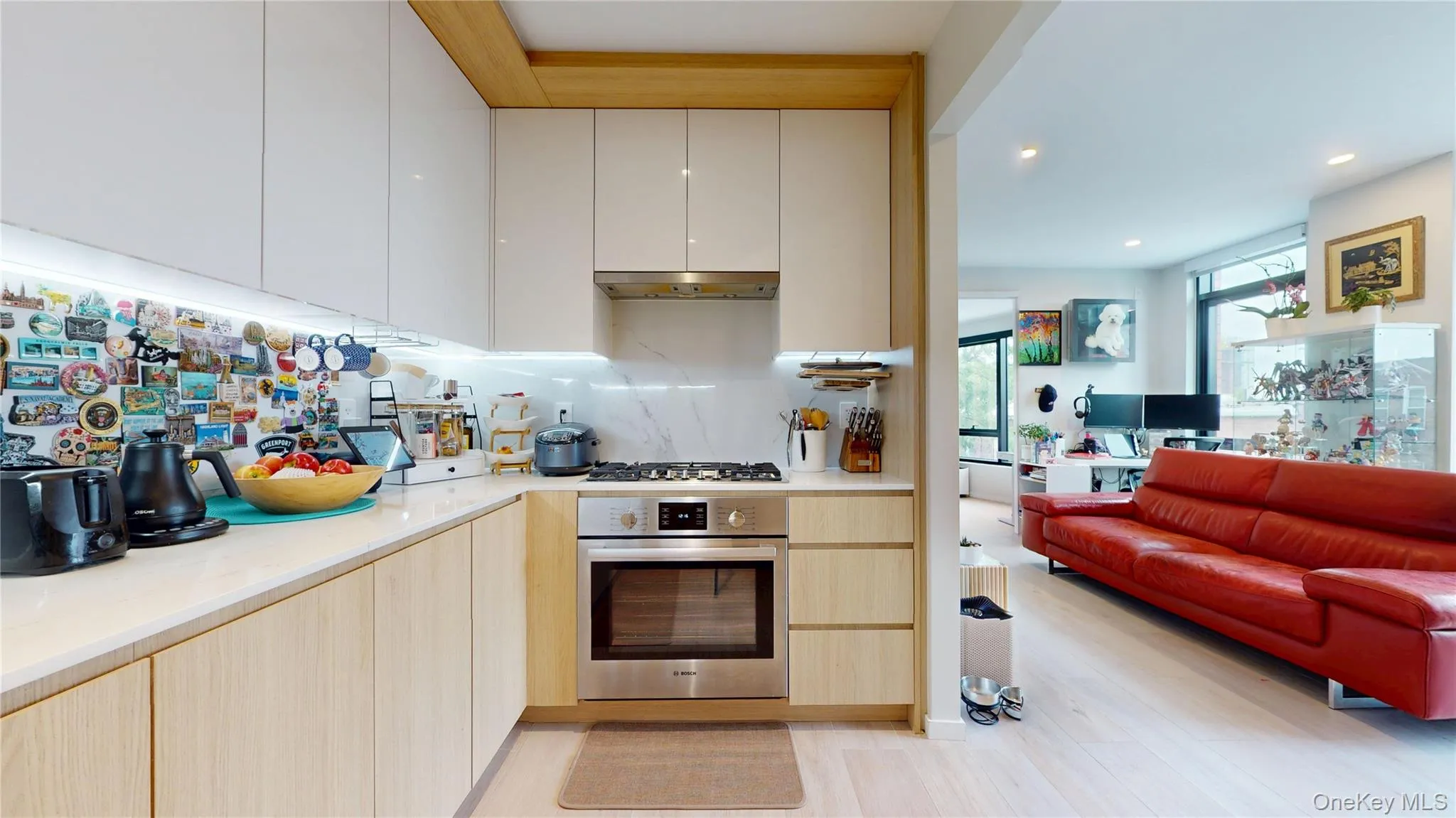 Kitchen with appliances with stainless steel finishes, modern cabinets, light countertops, and recessed lighting Kitchen with appliances with stainless steel finishes, modern cabinets, light countertops, and recessed lighting