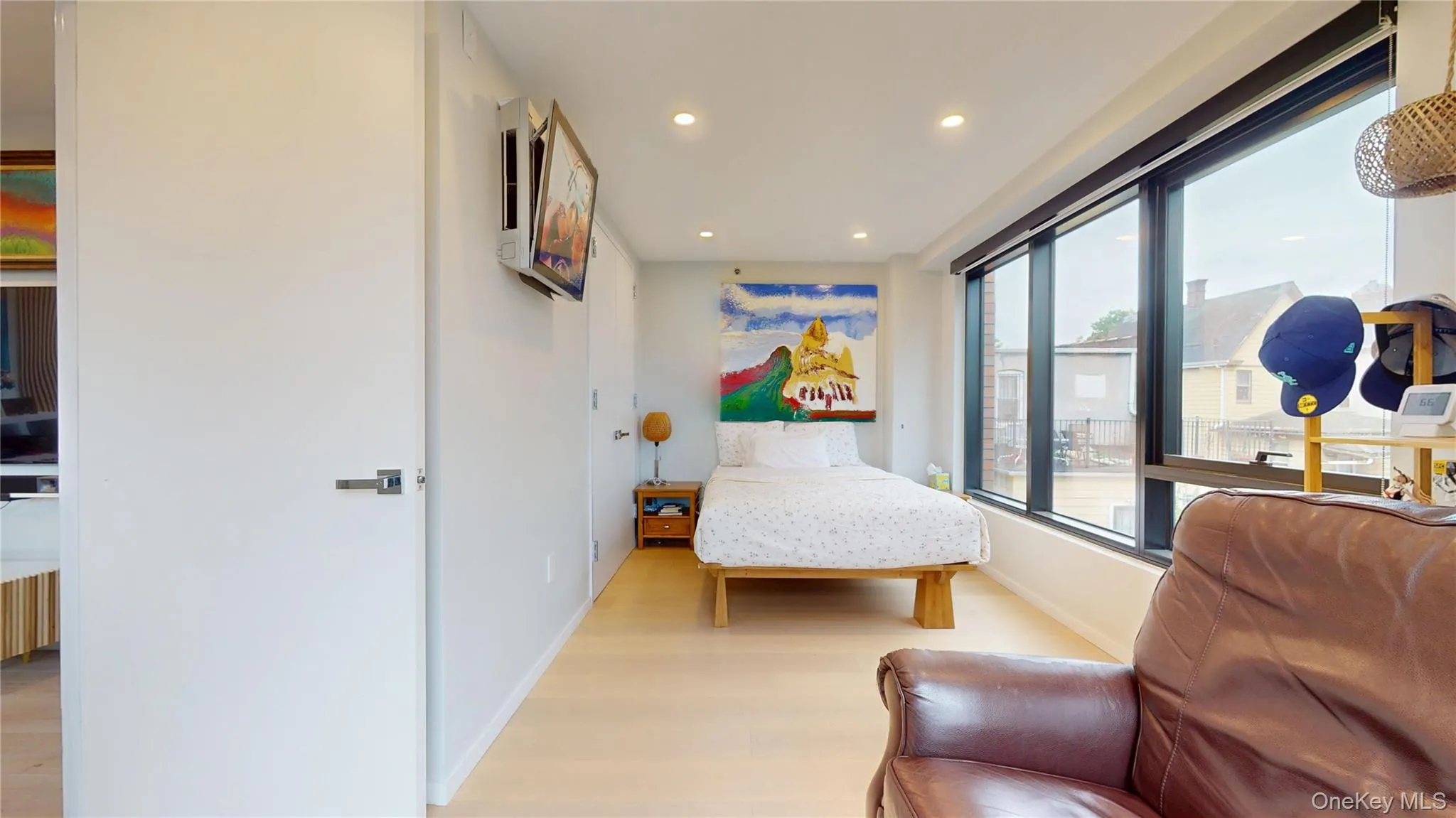 Bedroom featuring wood finished floors, recessed lighting, and baseboards Bedroom featuring wood finished floors, recessed lighting, and baseboards