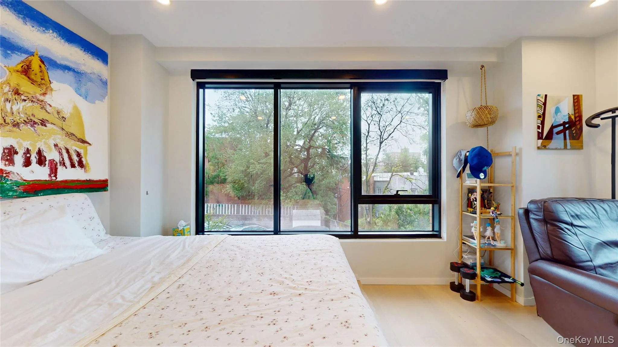 Bedroom featuring multiple windows, wood finished floors, recessed lighting, baseboards, and access to exterior Bedroom featuring multiple windows, wood finished floors, recessed lighting, baseboards, and access to exterior