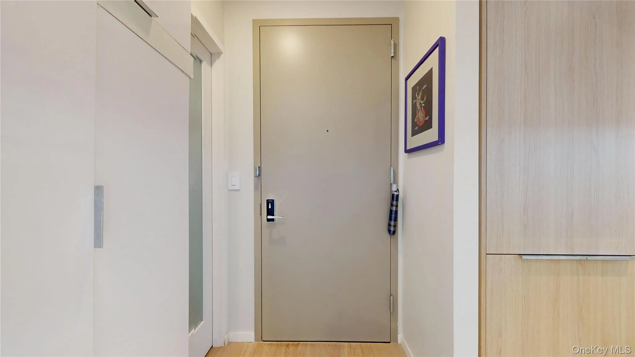 Doorway with baseboards and light wood finished floors Doorway with baseboards and light wood finished floors