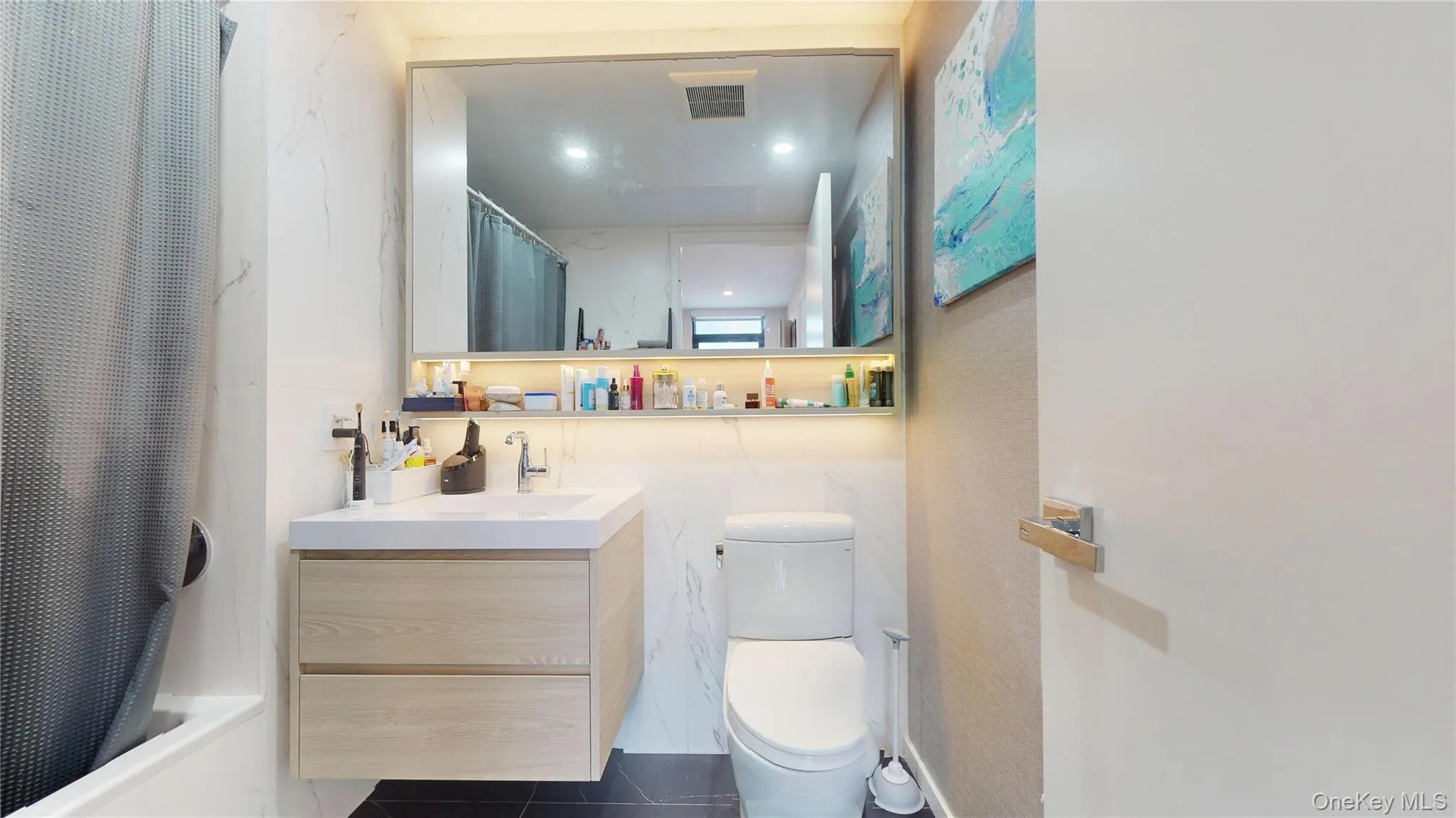 Full bath featuring tile patterned flooring, toilet, and vanity Full bath featuring tile patterned flooring, toilet, and vanity