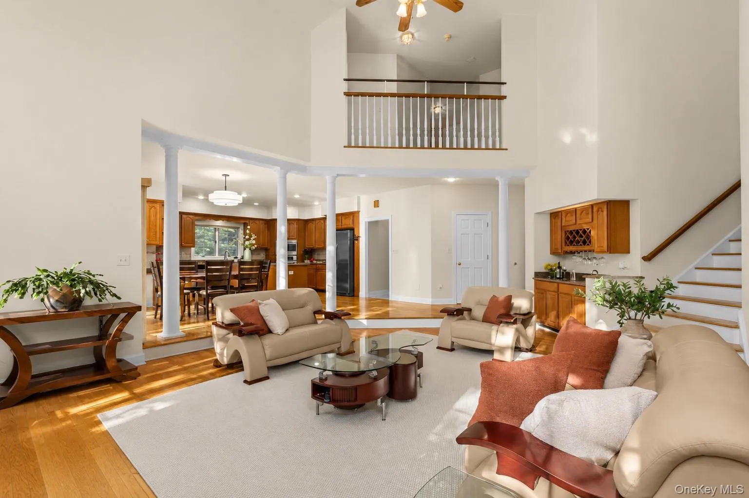 Soaring ceilings, abundant natural light, and a striking floor-to-ceiling brick fireplace create a dramatic yet inviting space for gathering and relaxation Soaring ceilings, abundant natural light, and a striking floor-to-ceiling brick fireplace create a dramatic yet inviting space for gathering and relaxation