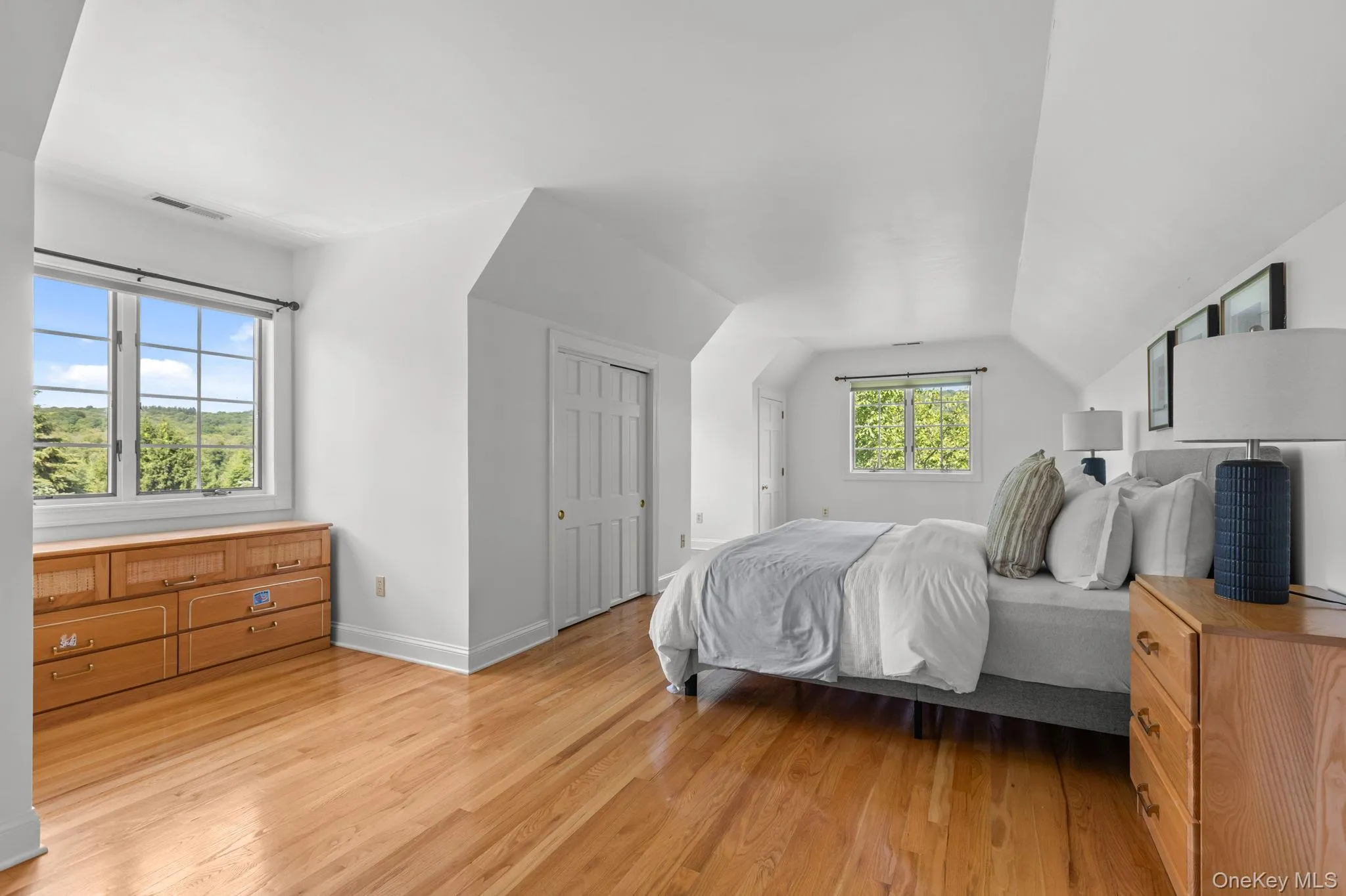 An inviting bonus room featuring high ceilings, ample closet space, and warm hardwood flooring. Although staged as a bedroom it is considered additional living space and not a bedroom An inviting bonus room featuring high ceilings, ample closet space, and warm hardwood flooring. Although staged as a bedroom it is considered additional living space and not a bedroom