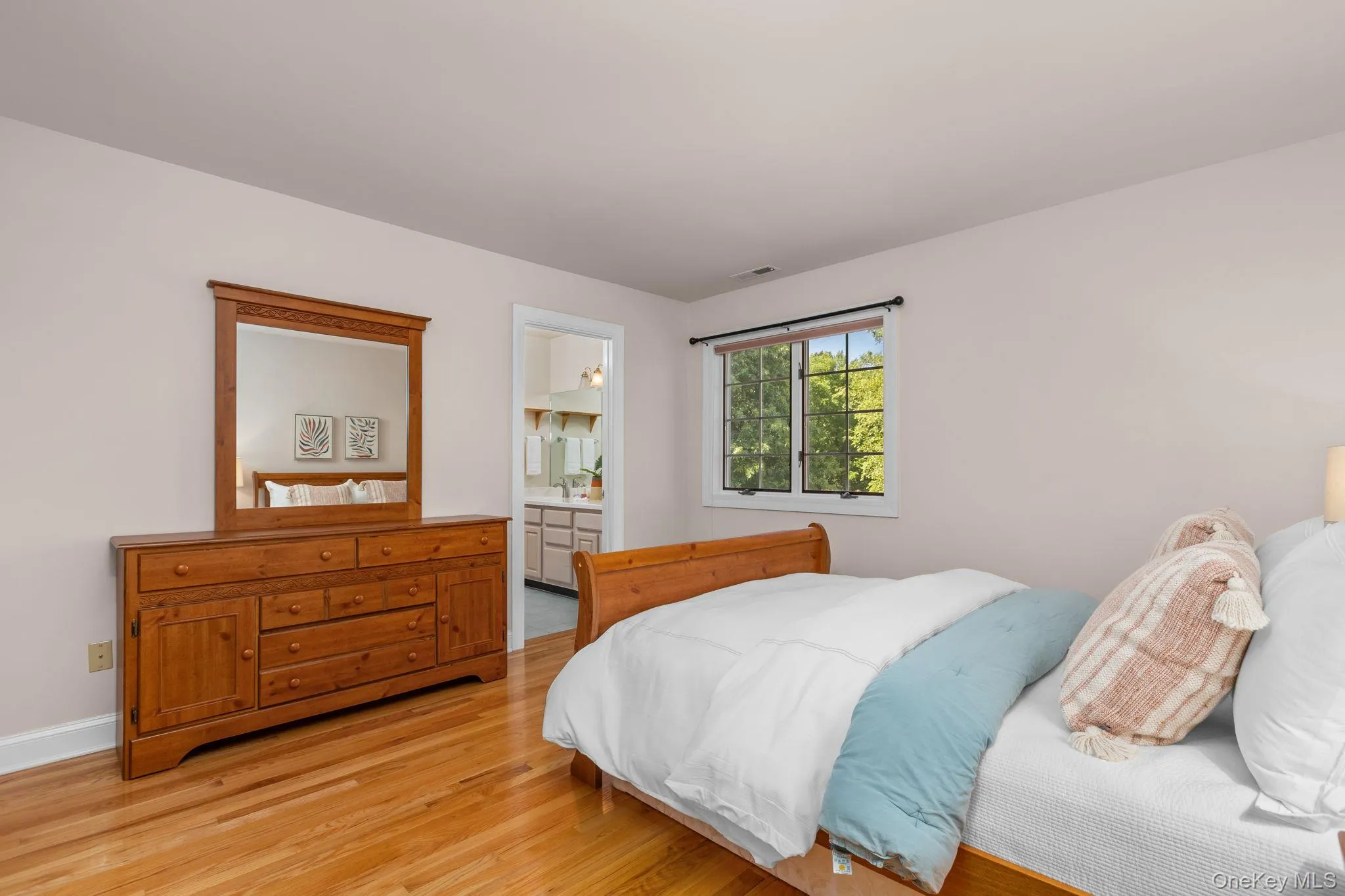 A spacious bedroom offering timeless hardwood floors and easy access to the adjoining bath. A spacious bedroom offering timeless hardwood floors and easy access to the adjoining bath.