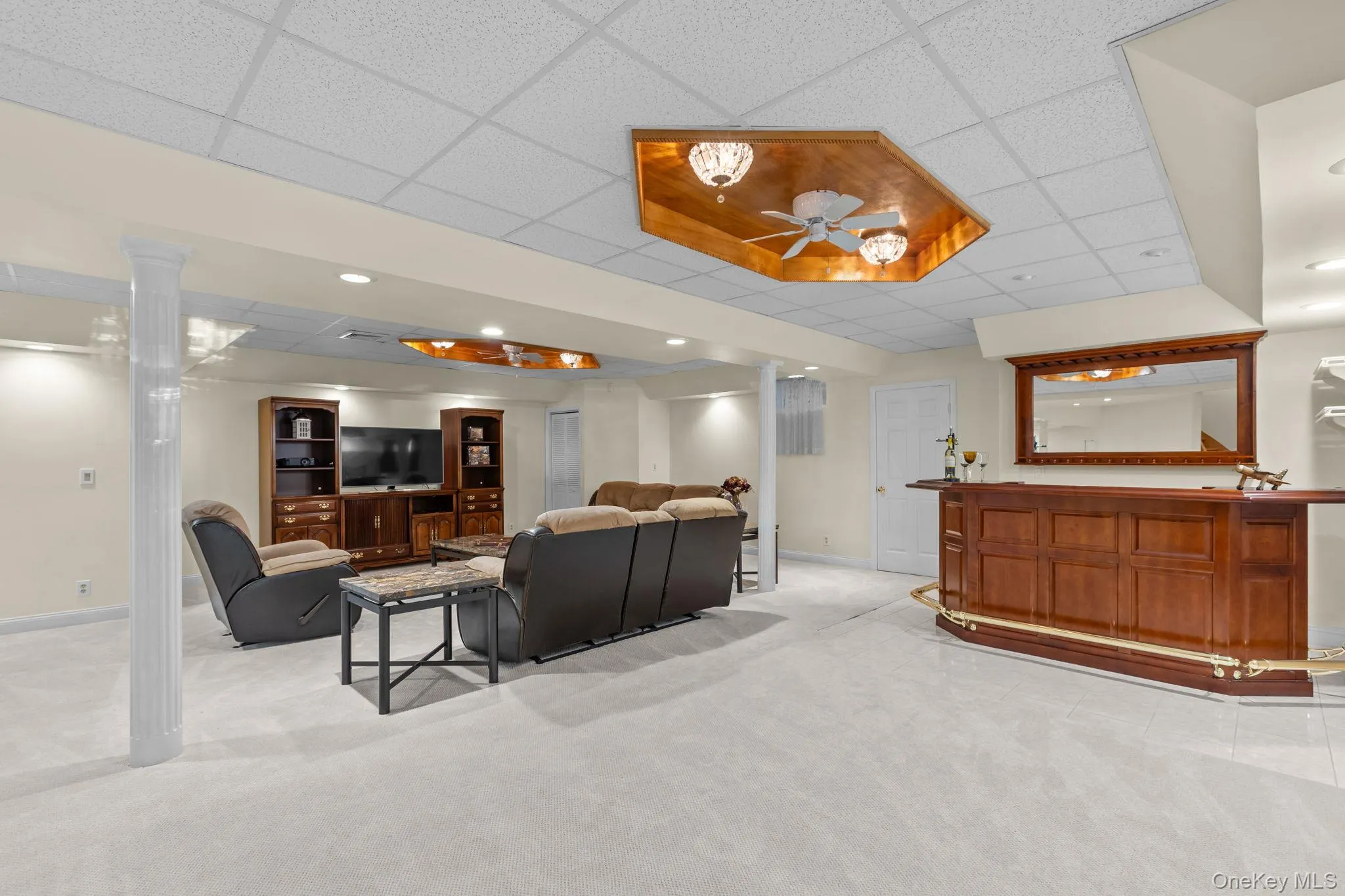 Large and versatile recreation space with a dedicated bar, recessed lighting, and carpeting—ideal for movie nights, game days, and gatherings. Large and versatile recreation space with a dedicated bar, recessed lighting, and carpeting—ideal for movie nights, game days, and gatherings.