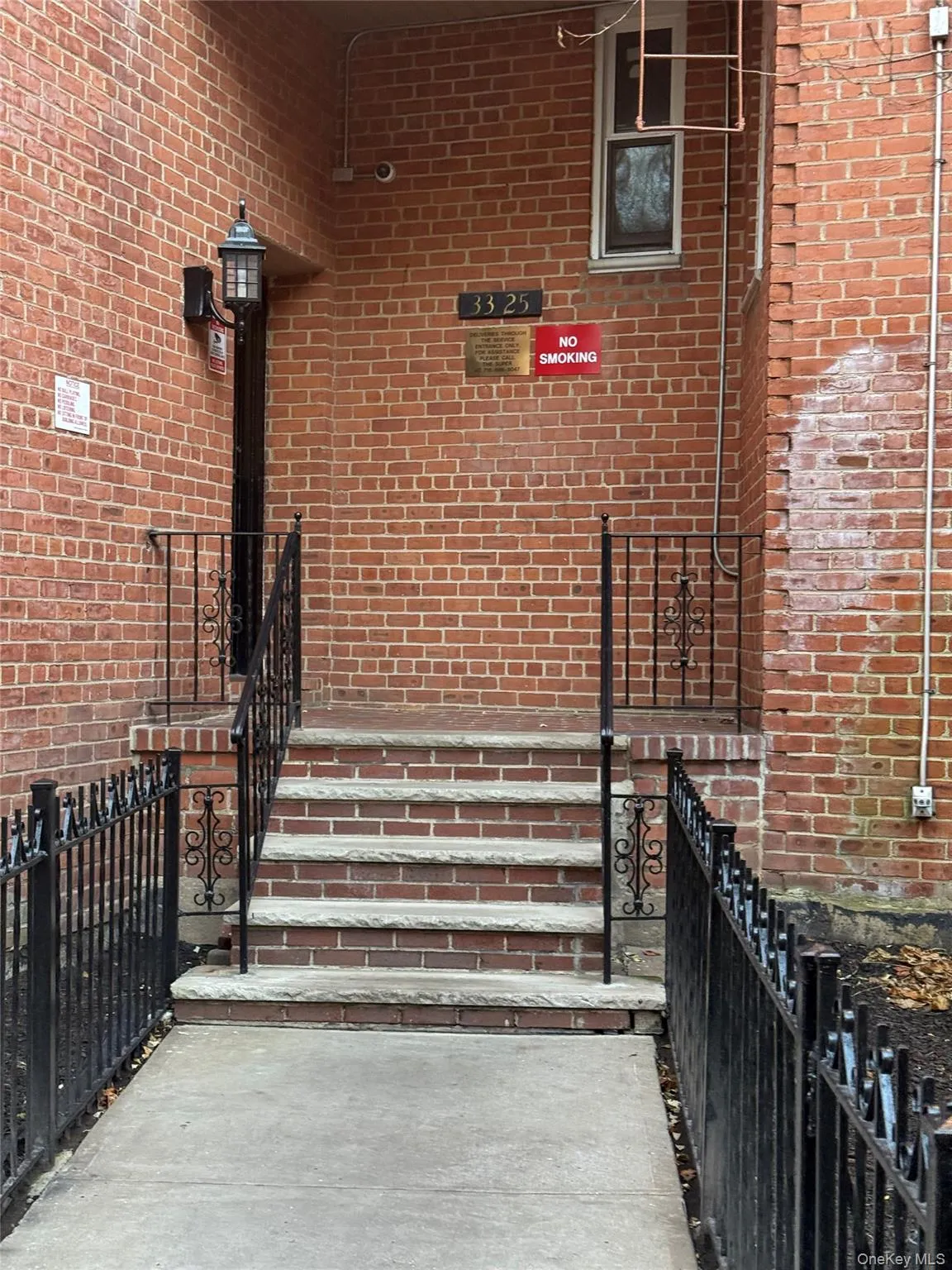 Doorway to property featuring brick siding Doorway to property featuring brick siding