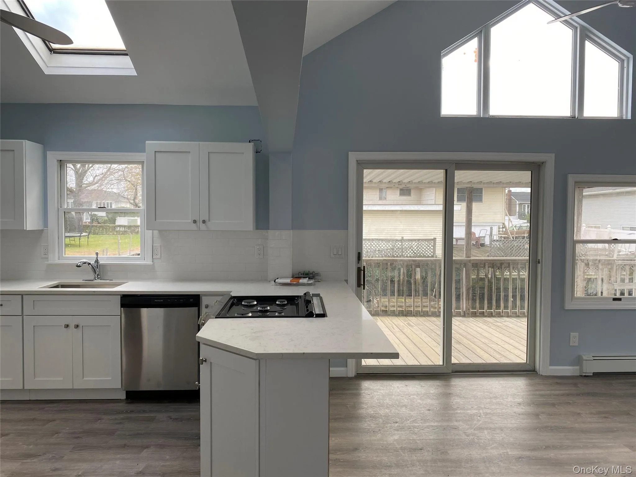 Light Filled Open Kitchen and Living Room with Sliding Doors To Back Deck and Dock Space Light Filled Open Kitchen and Living Room with Sliding Doors To Back Deck and Dock Space