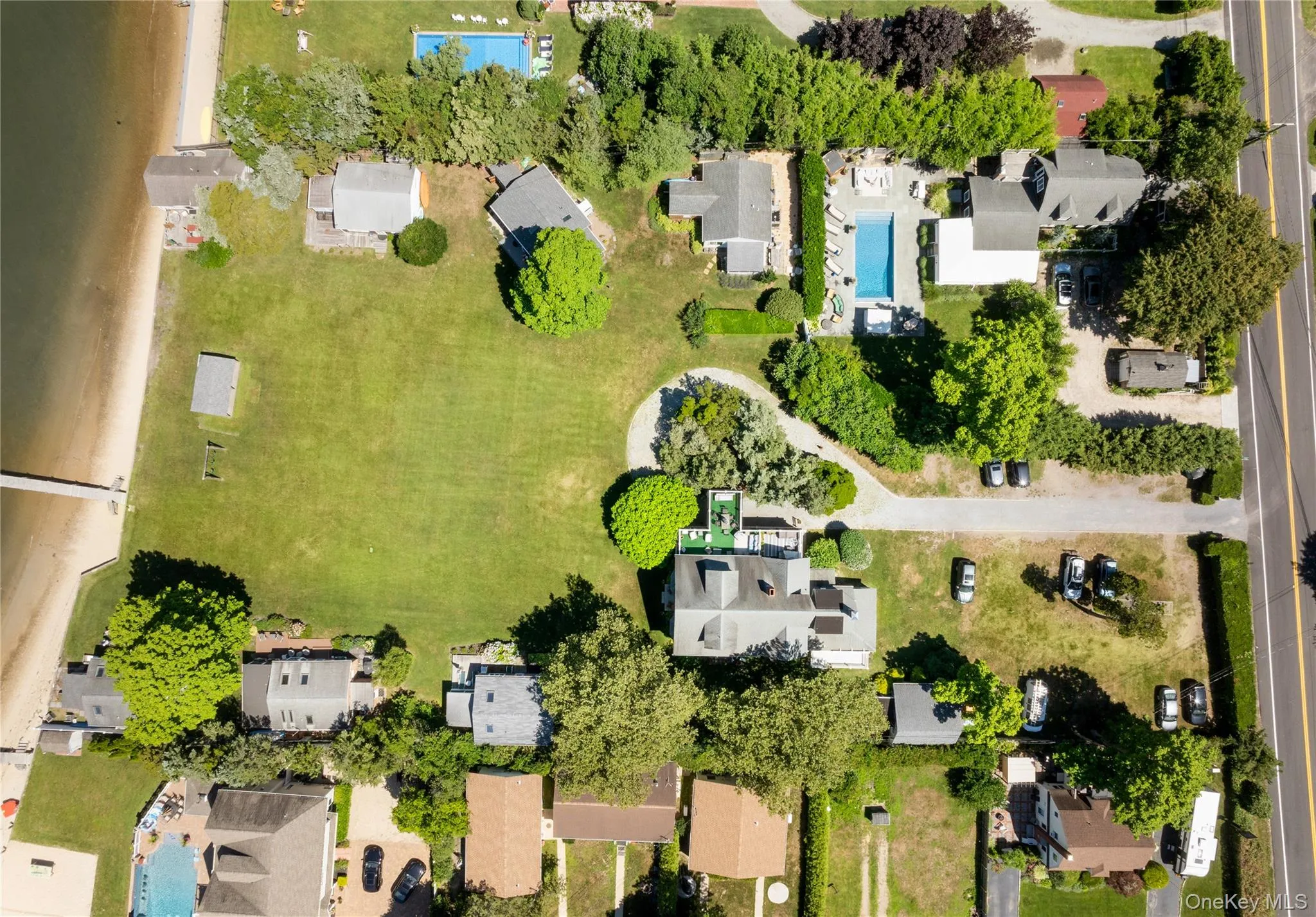 Aerial perspective of suburban area featuring a pool Aerial perspective of suburban area featuring a pool