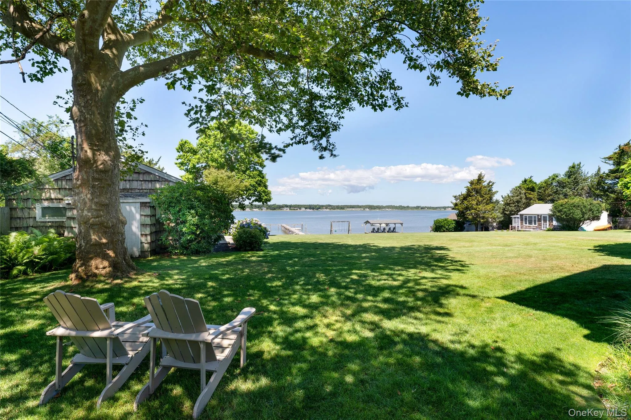 View of green lawn with a water view View of green lawn with a water view