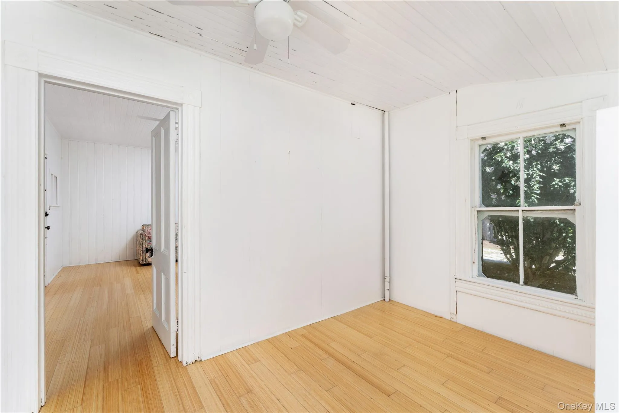 Spare room featuring light wood-style flooring and a ceiling fan Spare room featuring light wood-style flooring and a ceiling fan