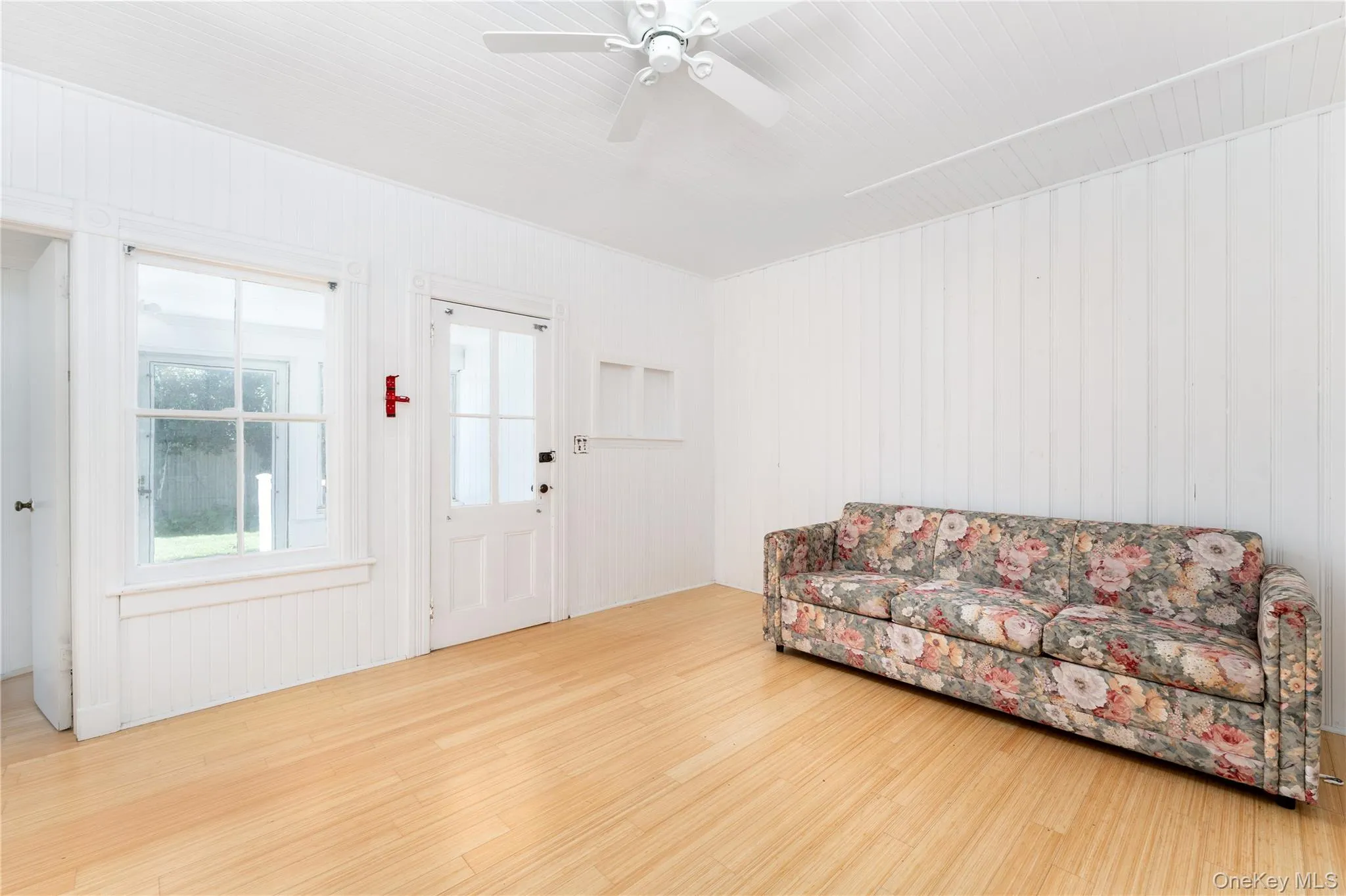 Living area with wood finished floors and a ceiling fan Living area with wood finished floors and a ceiling fan