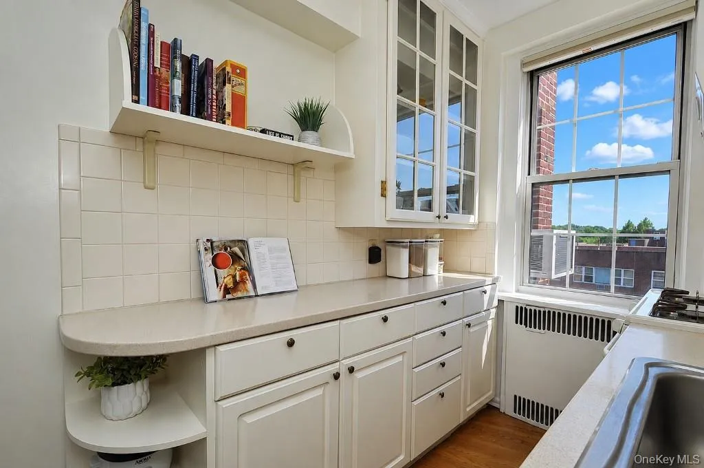 Updated Kitchen has Corian Counters, custom cabinets and a window for natural light and fresh air. Updated Kitchen has Corian Counters, custom cabinets and a window for natural light and fresh air.