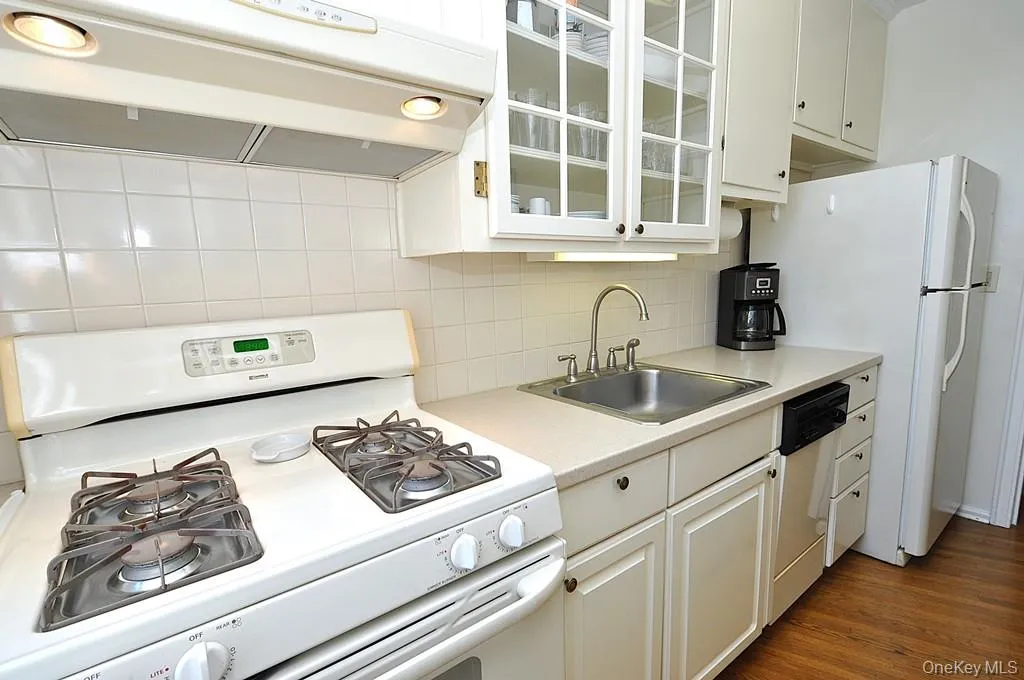 Updated Kitchen has Corian Counters, custom cabinets and a window for natural light and fresh air. Updated Kitchen has Corian Counters, custom cabinets and a window for natural light and fresh air.
