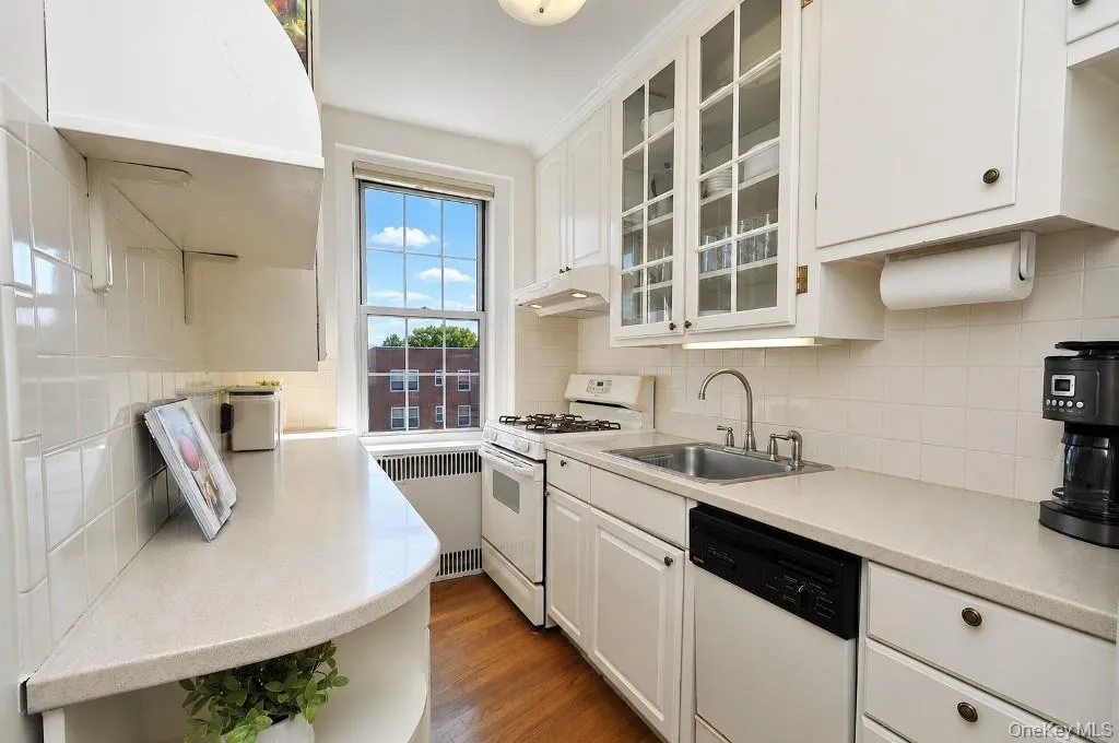 Updated Kitchen has Corian Counters, custom cabinets and a window for natural light and fresh air. Updated Kitchen has Corian Counters, custom cabinets and a window for natural light and fresh air.
