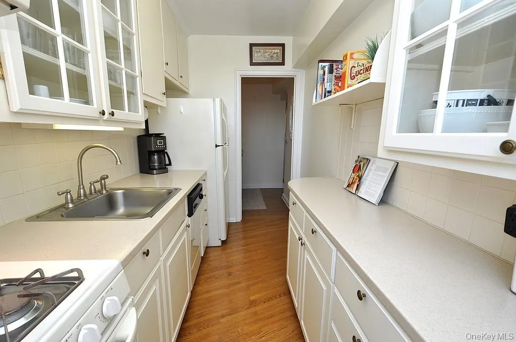 Updated Kitchen has Corian Counters, custom cabinets and a window for natural light and fresh air. Updated Kitchen has Corian Counters, custom cabinets and a window for natural light and fresh air.