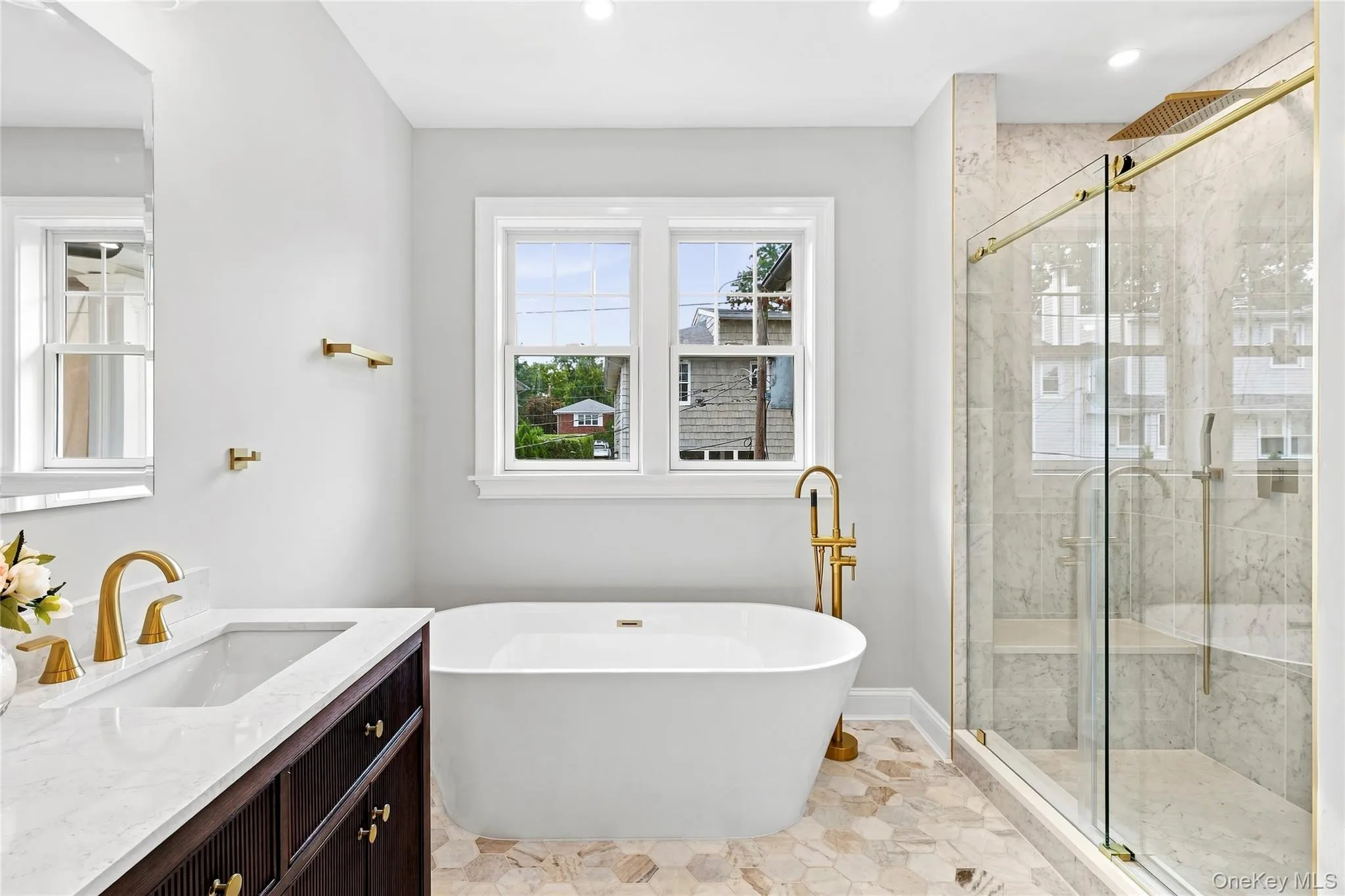 Full spa-like bath featuring a double vanity, a socking tub, and radiant floors Full spa-like bath featuring a double vanity, a socking tub, and radiant floors