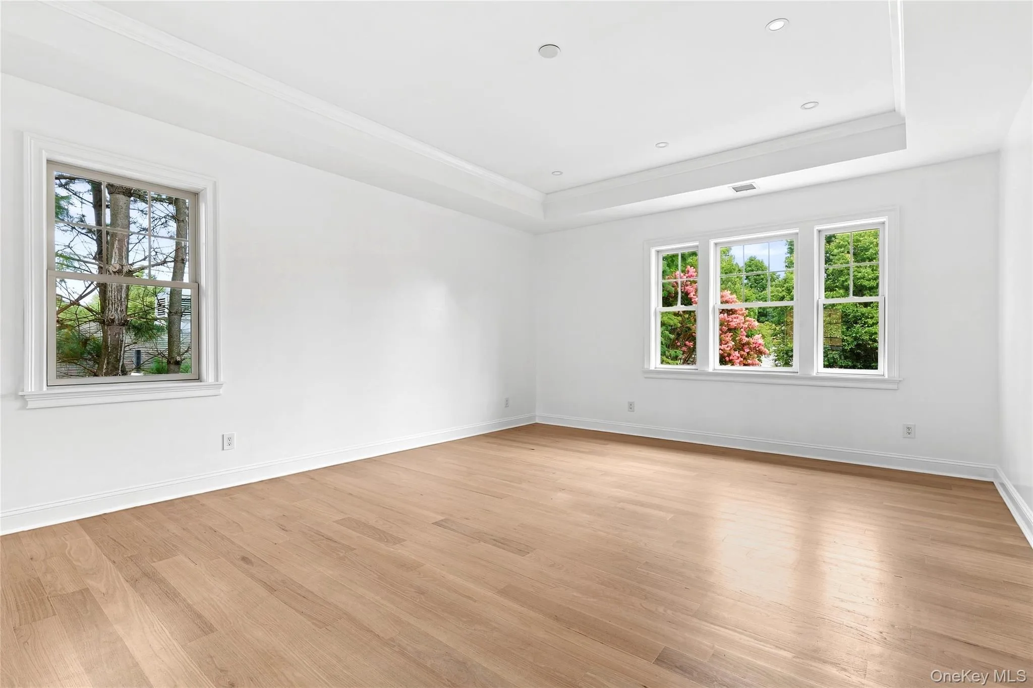 Light filled primary bedroom with recessed lighting Light filled primary bedroom with recessed lighting