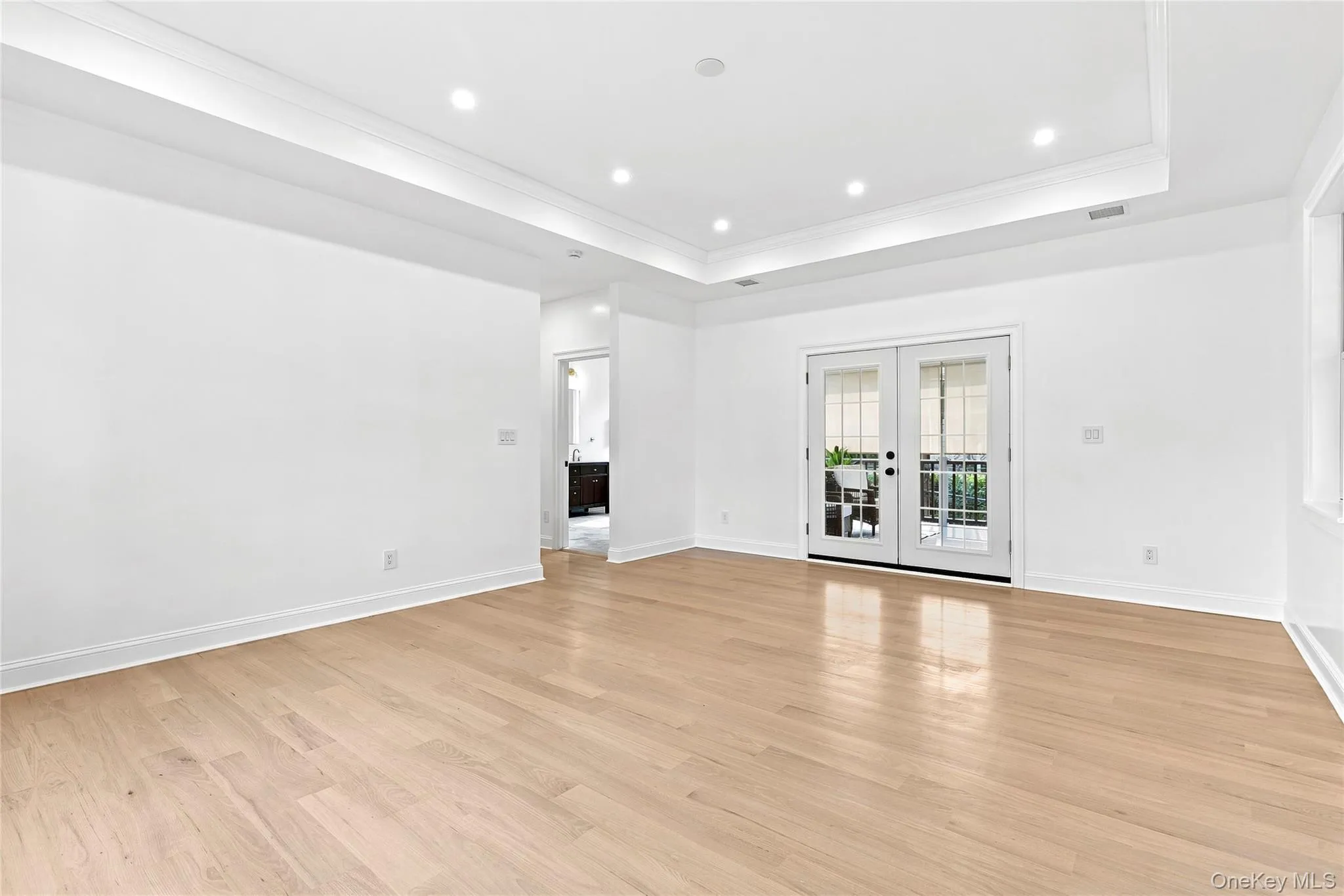 Spacious primary bedroom with private Trex deck Spacious primary bedroom with private Trex deck