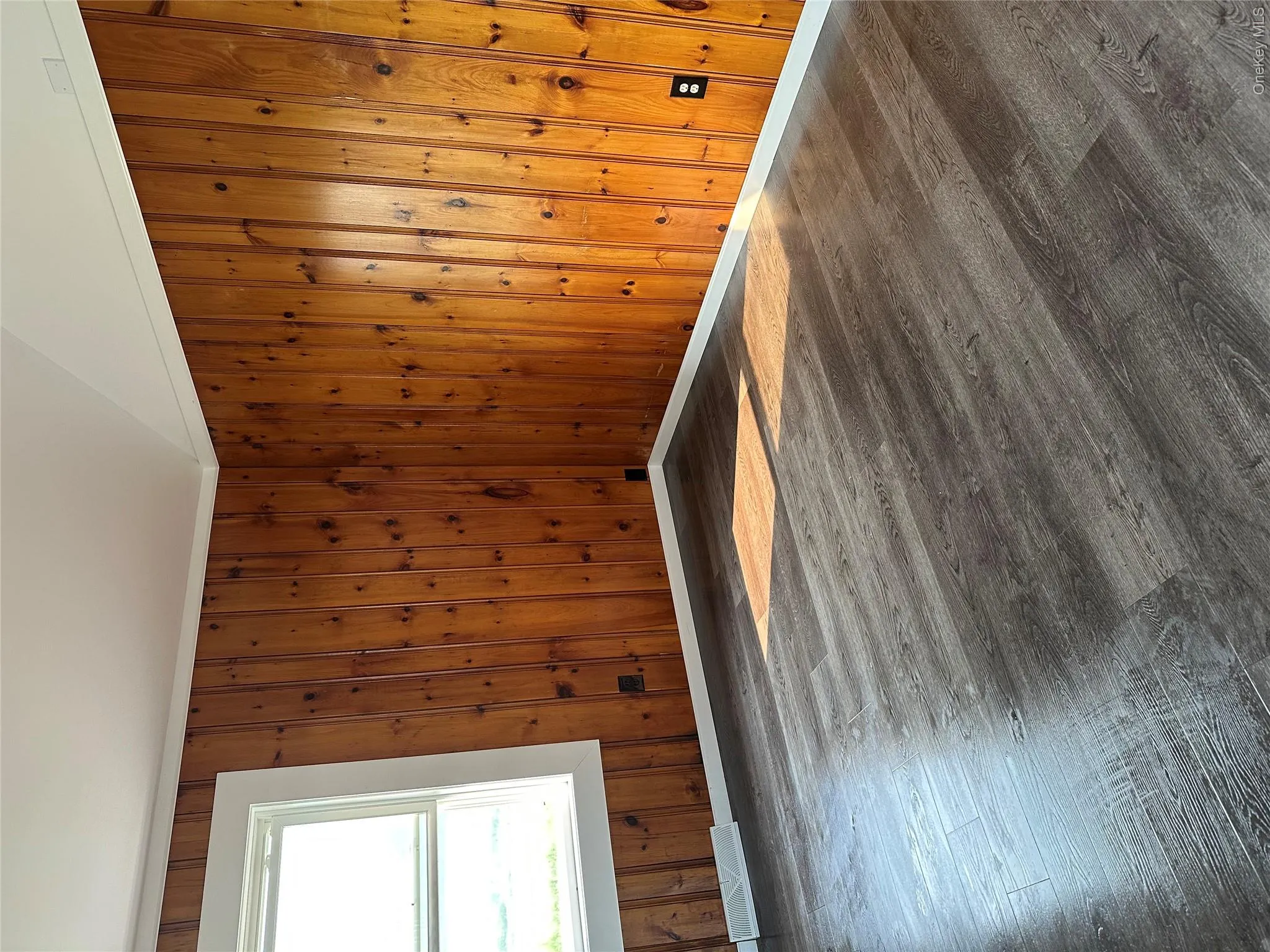 Interior space featuring wood-finish flooring and paneled walls Interior space featuring wood-finish flooring and paneled walls