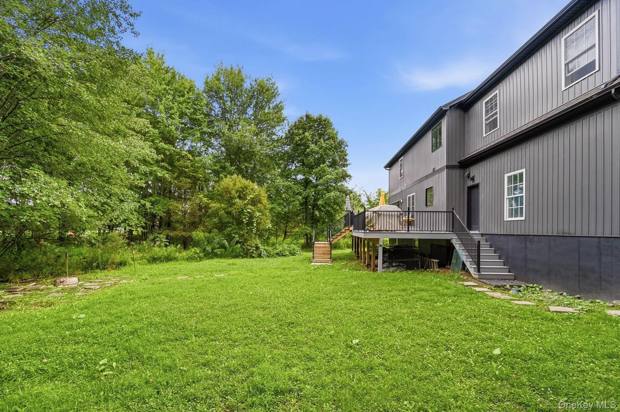 Expansive green lawn providing abundant outdoor space Expansive green lawn providing abundant outdoor space
