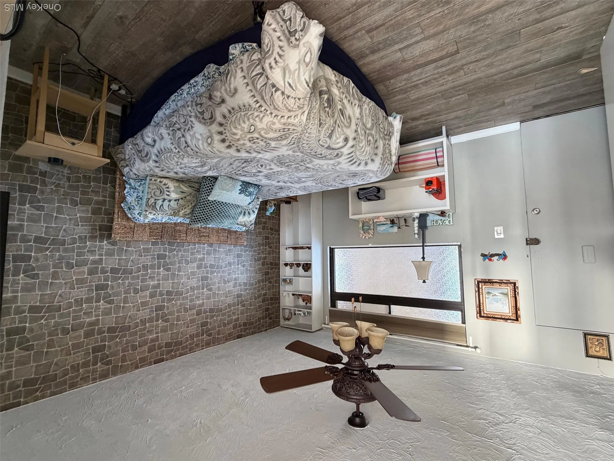 Bedroom featuring wood finished floors, a textured ceiling, and ceiling fan Bedroom featuring wood finished floors, a textured ceiling, and ceiling fan