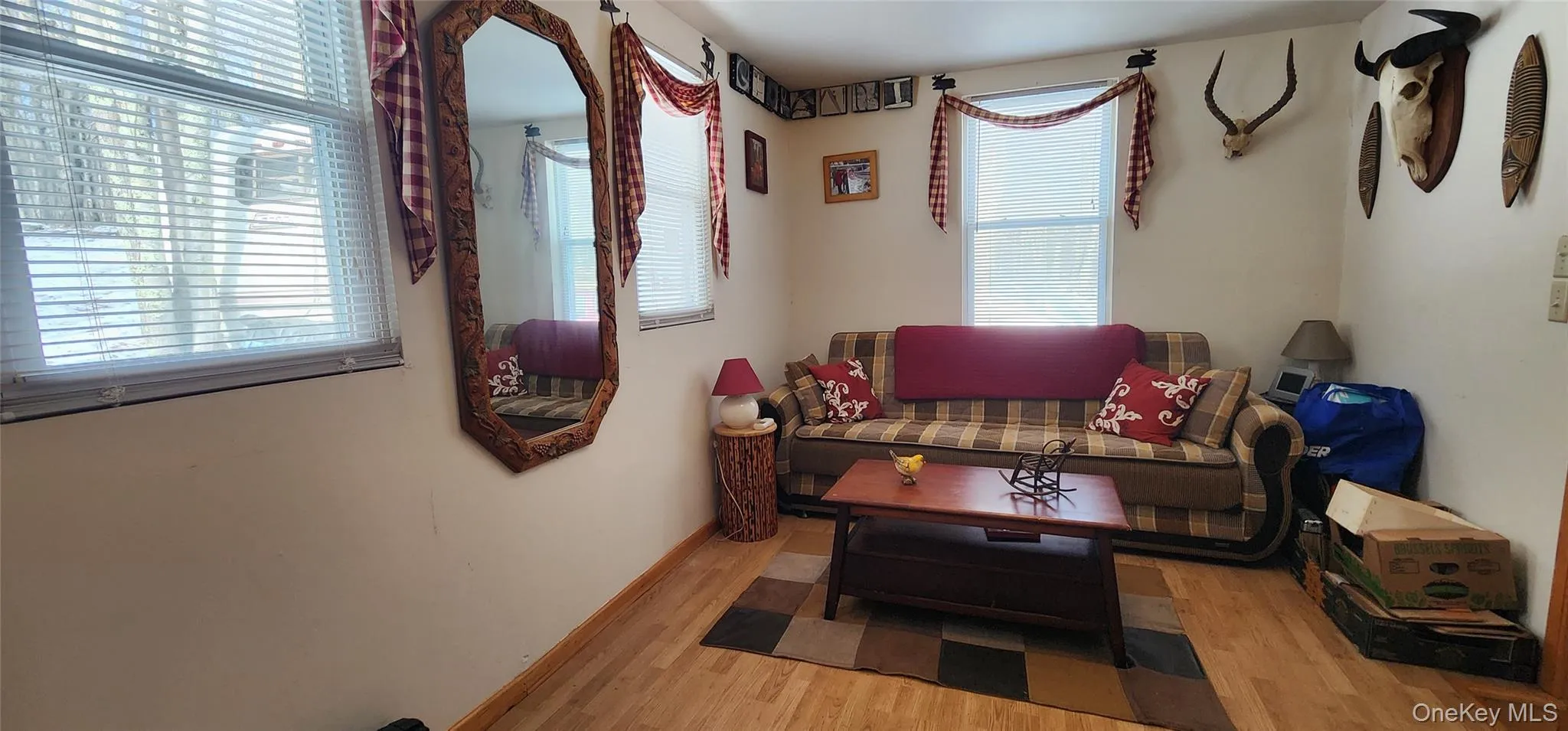 Living room with light hardwood / wood-style flooring and a healthy amount of sunlight Living room with light hardwood / wood-style flooring and a healthy amount of sunlight