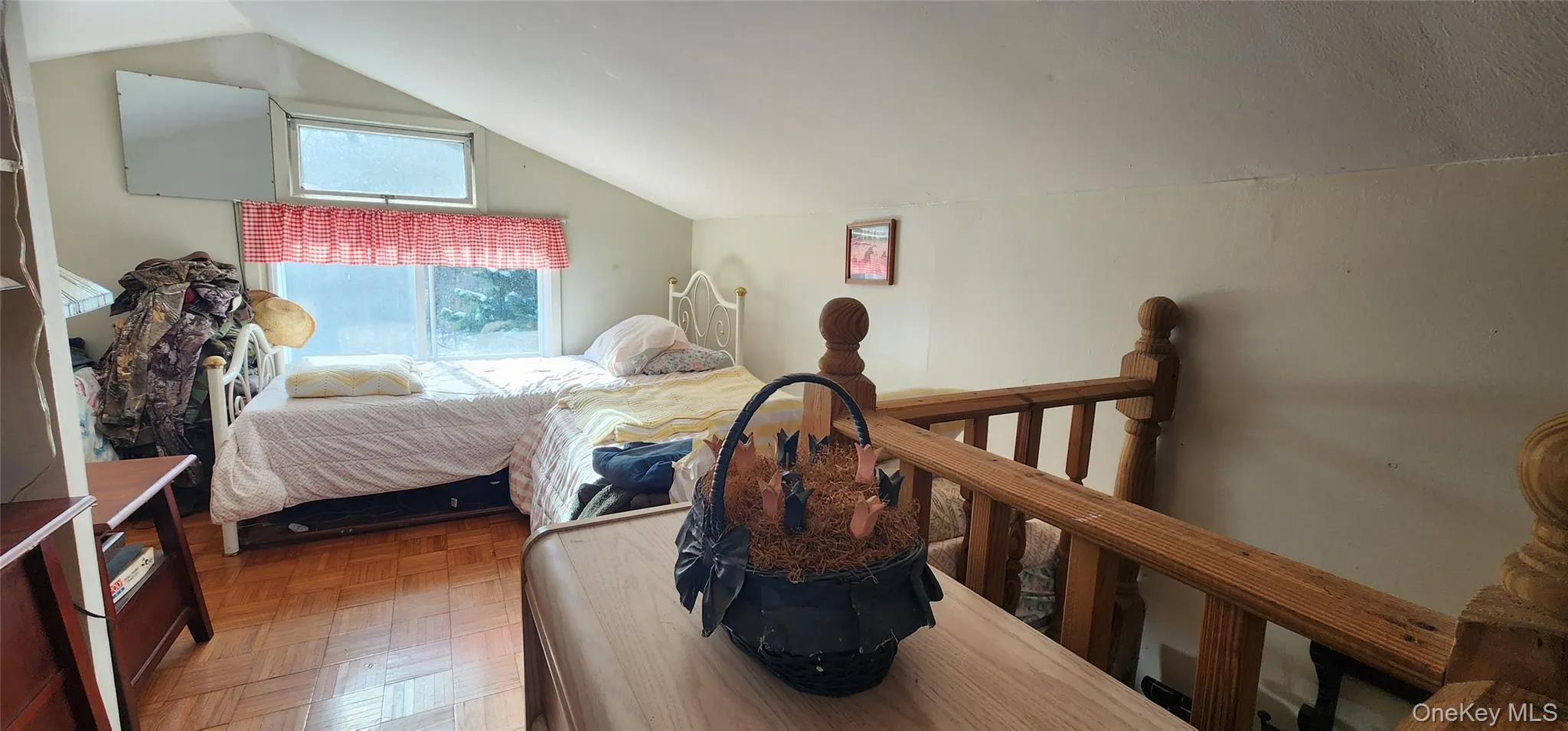 Bedroom featuring parquet floors and vaulted ceiling Bedroom featuring parquet floors and vaulted ceiling