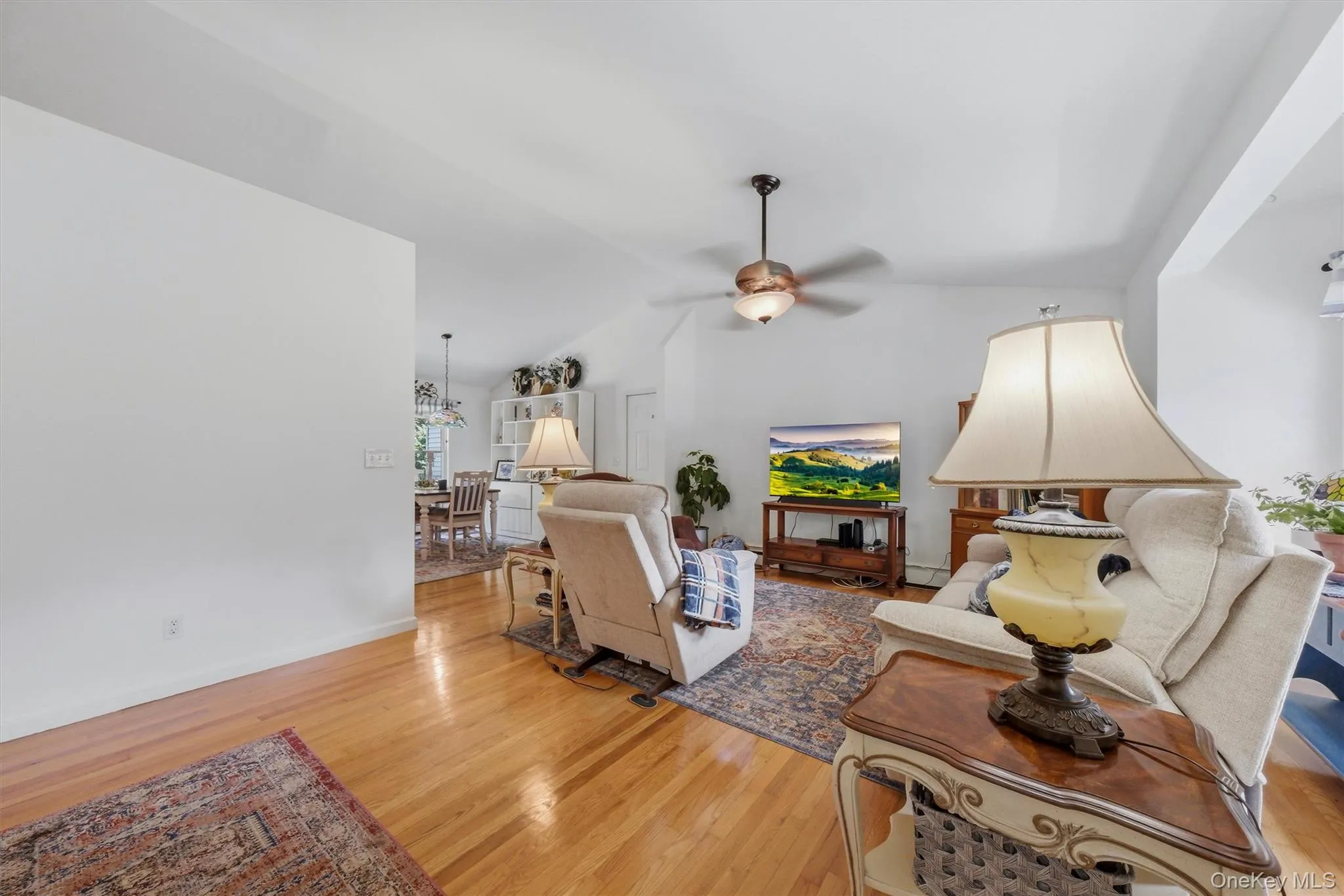 Vaulted ceiling, hardwood flooring, ceiling fan, and recessed lighting Vaulted ceiling, hardwood flooring, ceiling fan, and recessed lighting