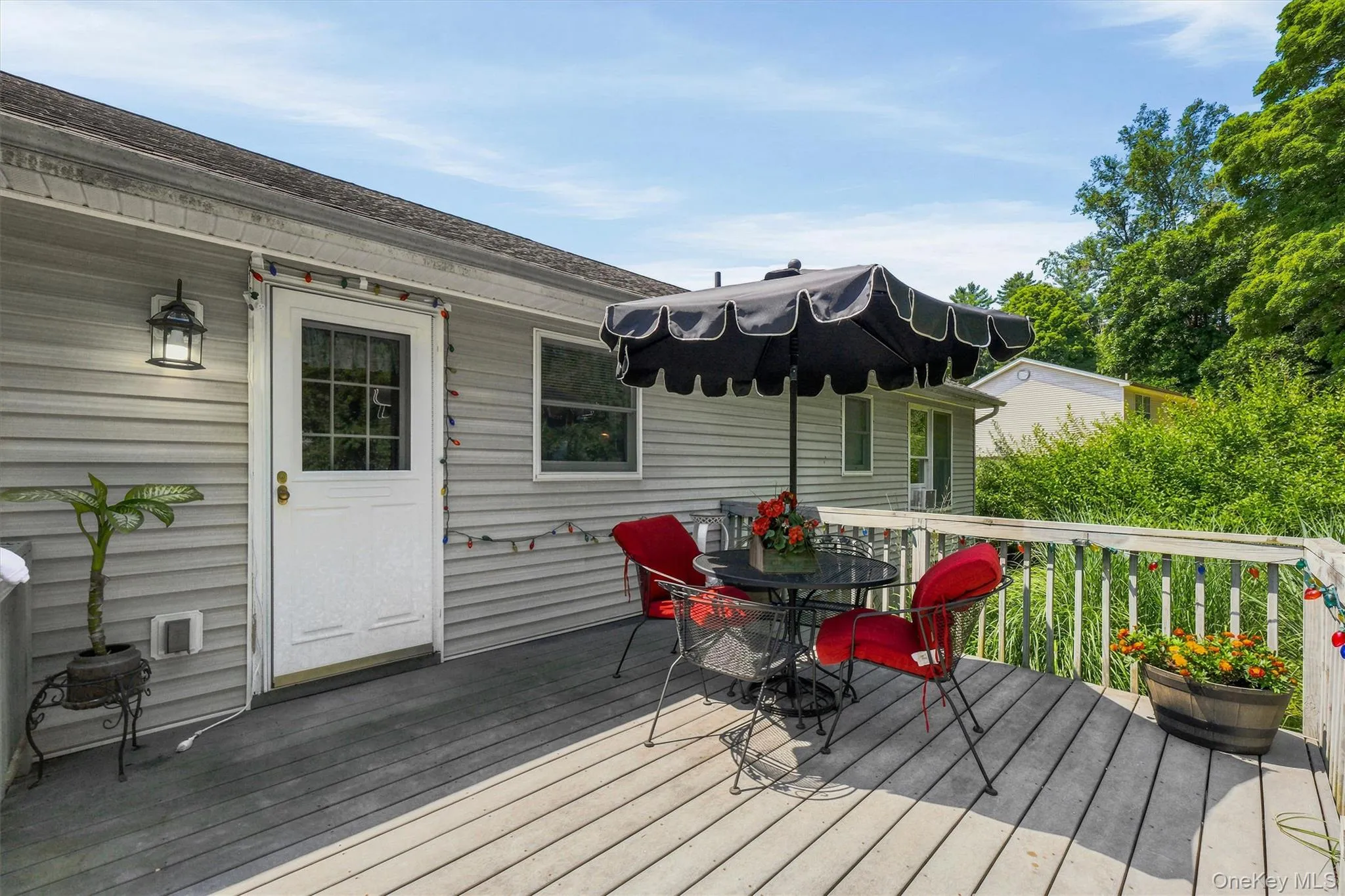 Expansive outdoor deck with a sturdy wood railing and a white paneled door Expansive outdoor deck with a sturdy wood railing and a white paneled door