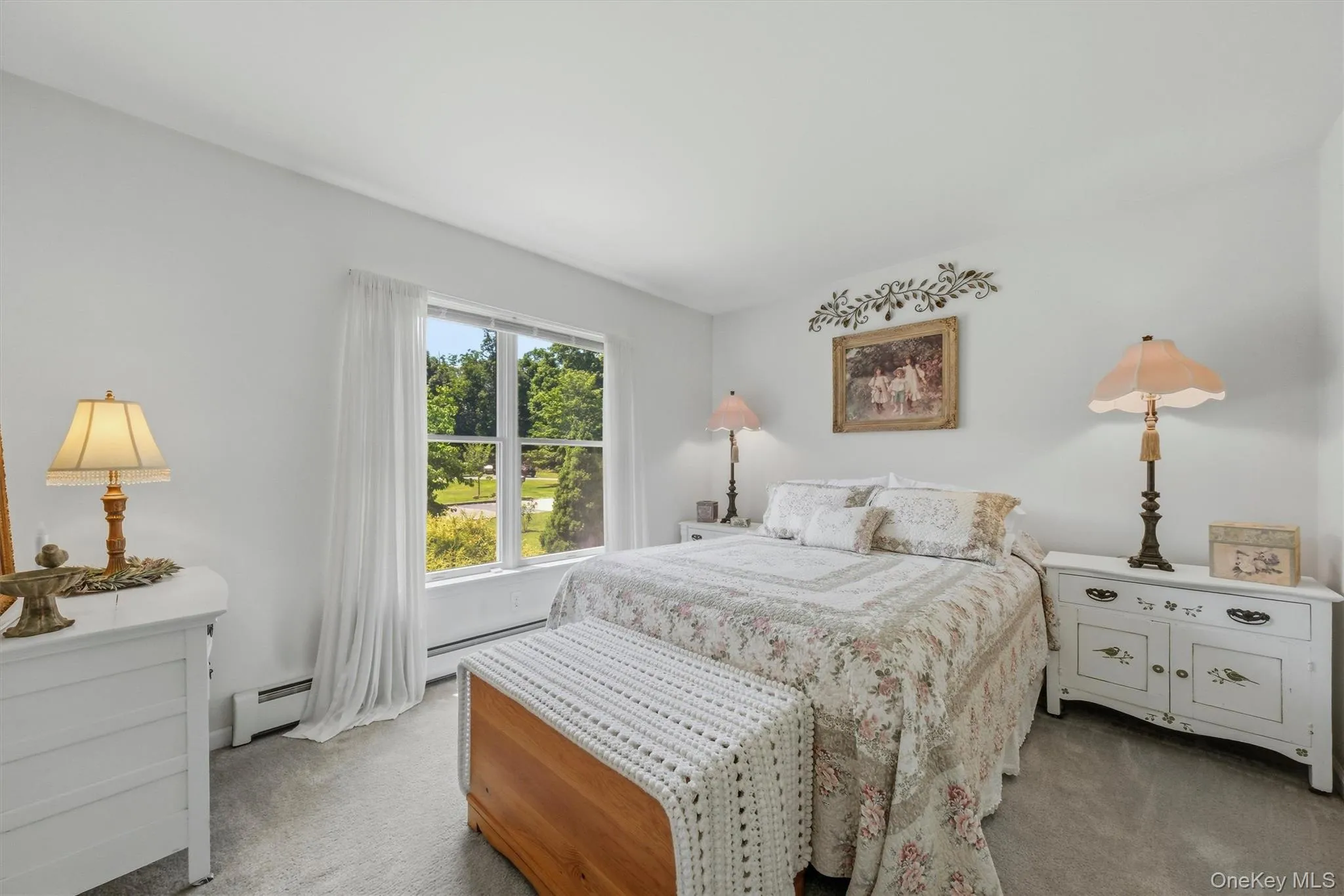 Expansive window, neutral wall color, and carpeted flooring Expansive window, neutral wall color, and carpeted flooring