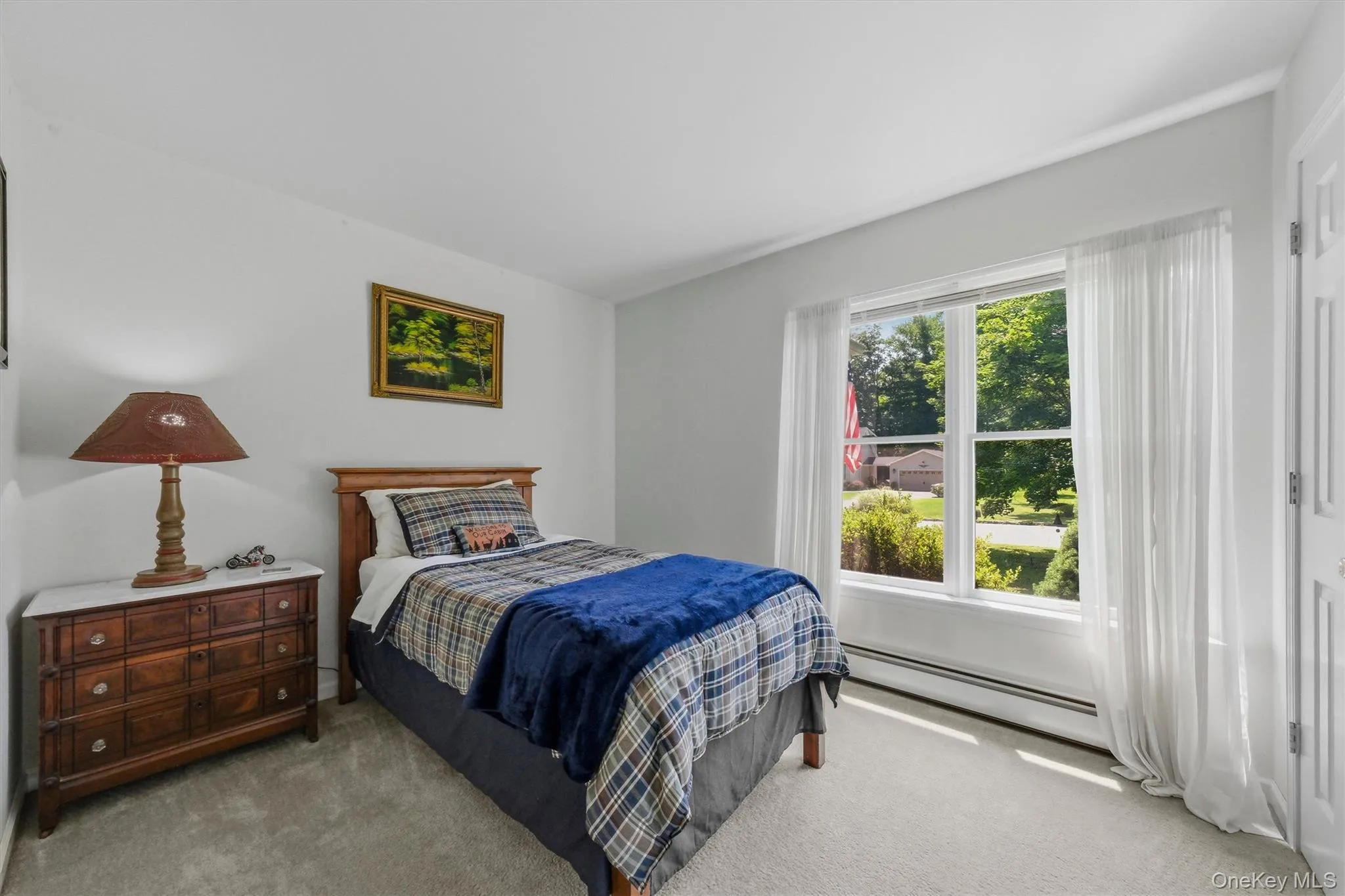 Bright room with light gray walls, white trim, and a window offering abundant natural light Bright room with light gray walls, white trim, and a window offering abundant natural light