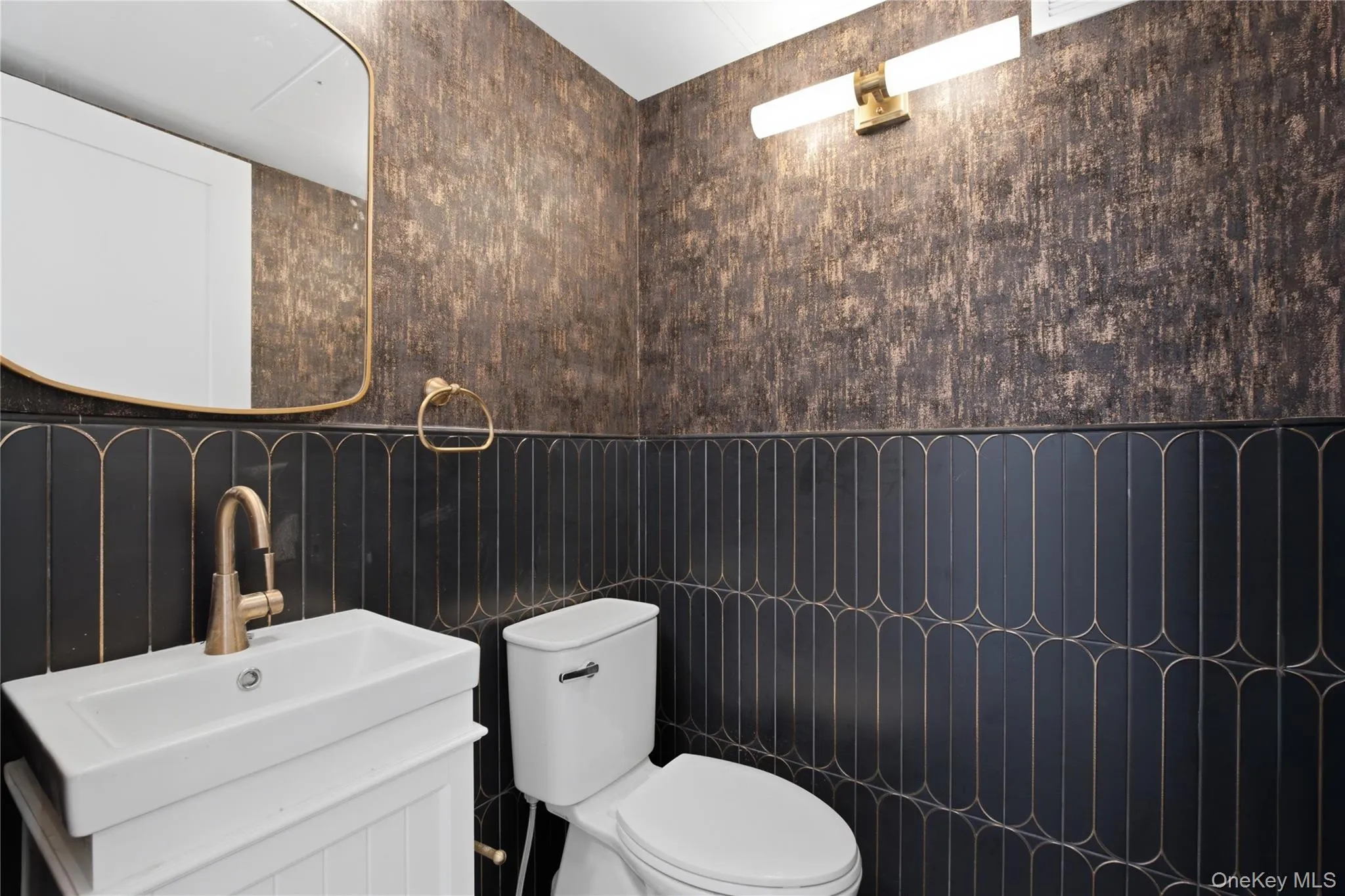 Elegant Powder Room — A stylish half bath featuring a modern vanity, dramatic tilework, contemporary fixtures, and sophisticated finishes that create a sleek, upscale feel. Elegant Powder Room — A stylish half bath featuring a modern vanity, dramatic tilework, contemporary fixtures, and sophisticated finishes that create a sleek, upscale feel.