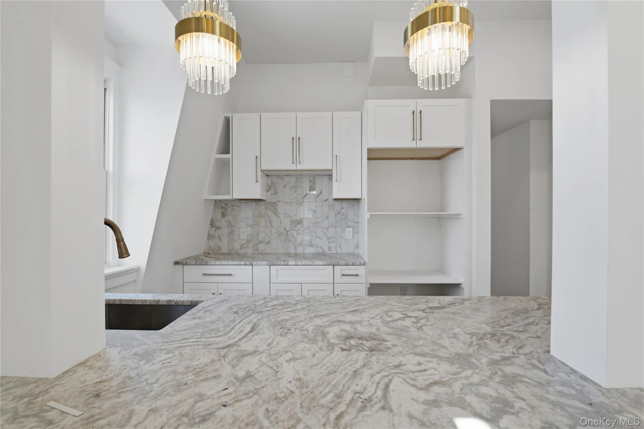 Beautiful Modern Kitchen — A bright, sophisticated kitchen featuring elegant stone countertops, crisp white cabinetry, stylish pendant lighting, and contemporary finishes, creating a clean and inviting space for cooking and entertaining. Beautiful Modern Kitchen — A bright, sophisticated kitchen featuring elegant stone countertops, crisp white cabinetry, stylish pendant lighting, and contemporary finishes, creating a clean and inviting space for cooking and entertaining.