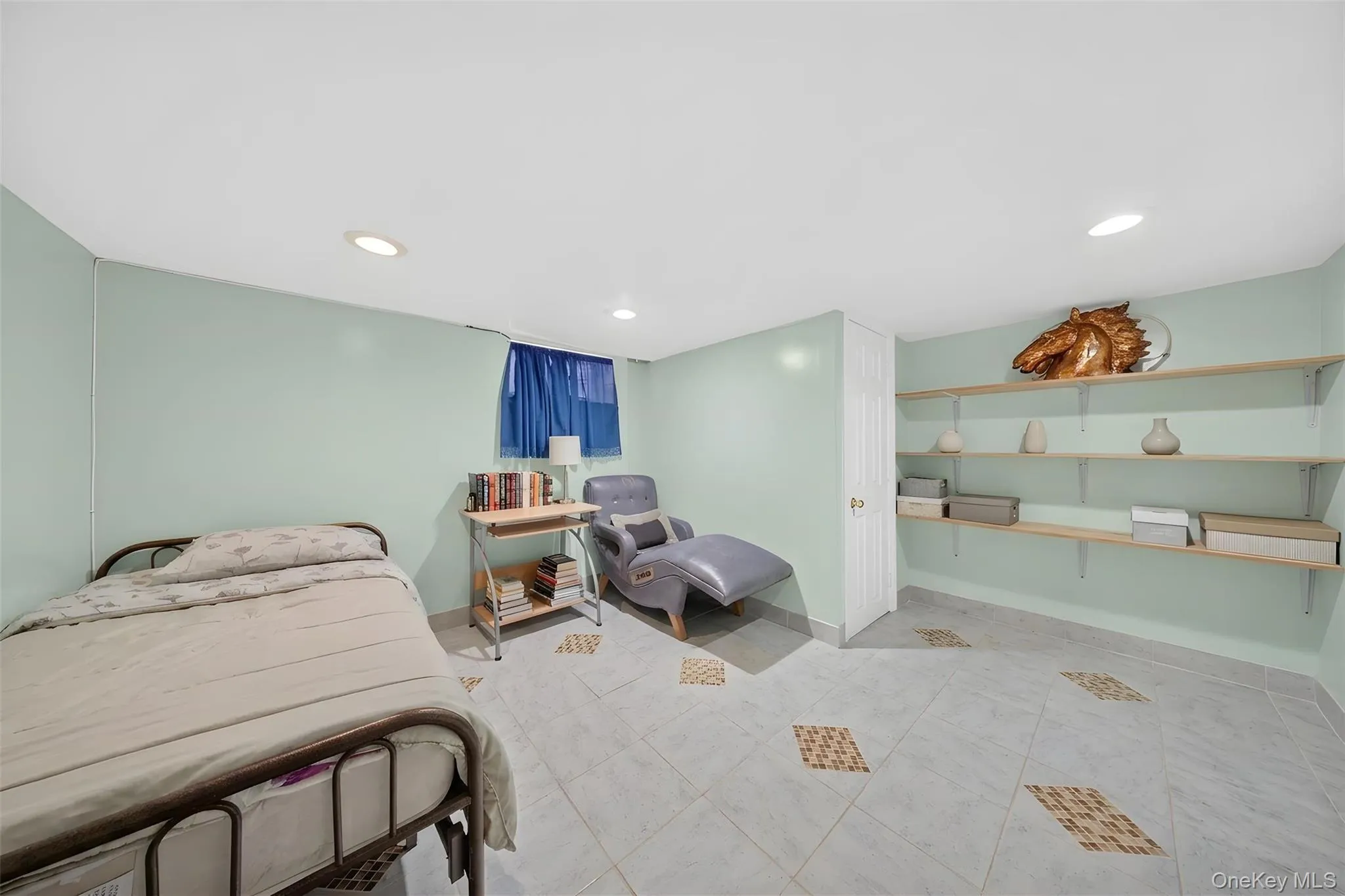 Recessed lighting illuminates a room featuring light green walls and unique patterned tile flooring Recessed lighting illuminates a room featuring light green walls and unique patterned tile flooring