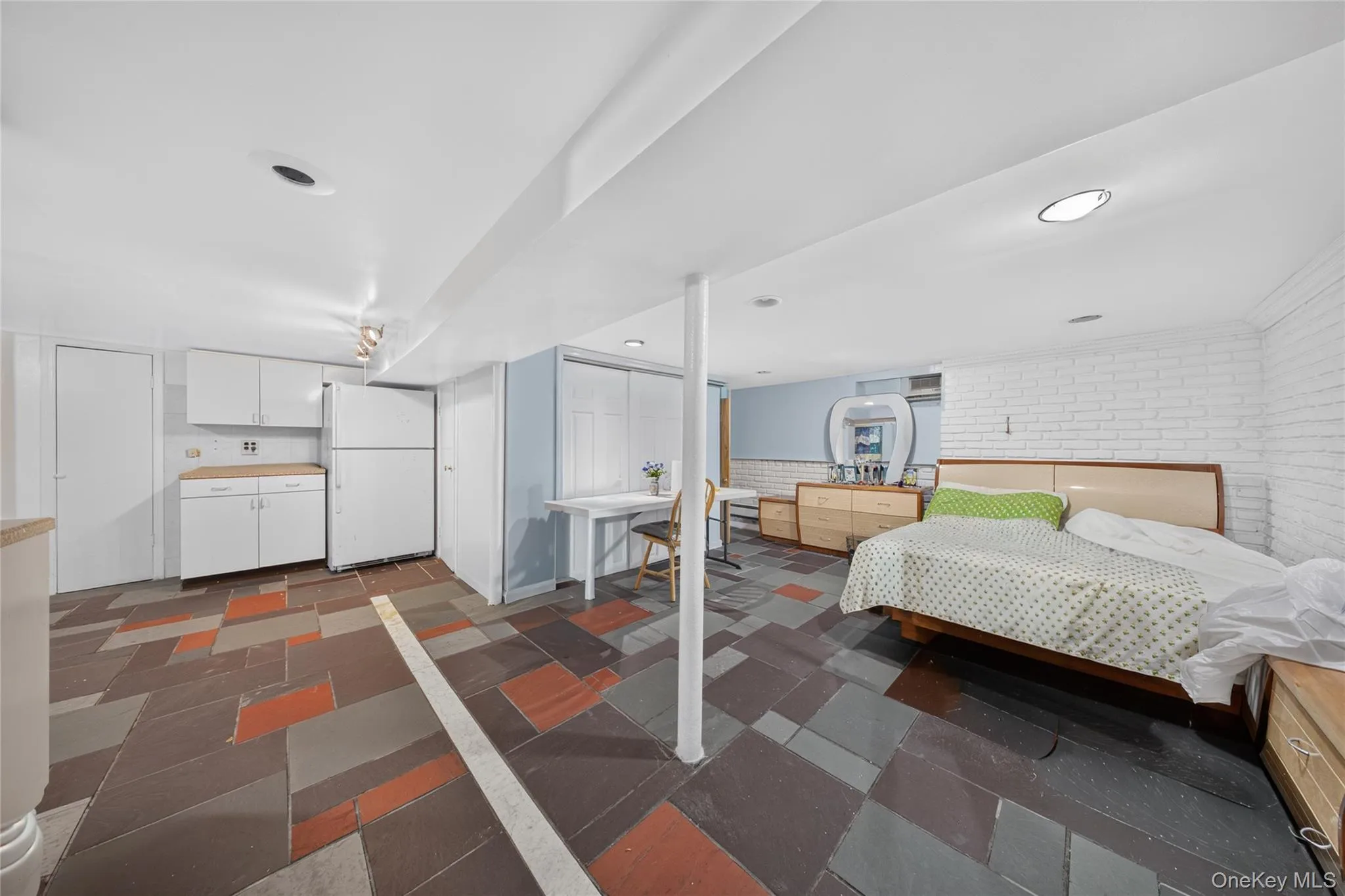 Spacious room featuring multi-toned slate-style flooring Spacious room featuring multi-toned slate-style flooring