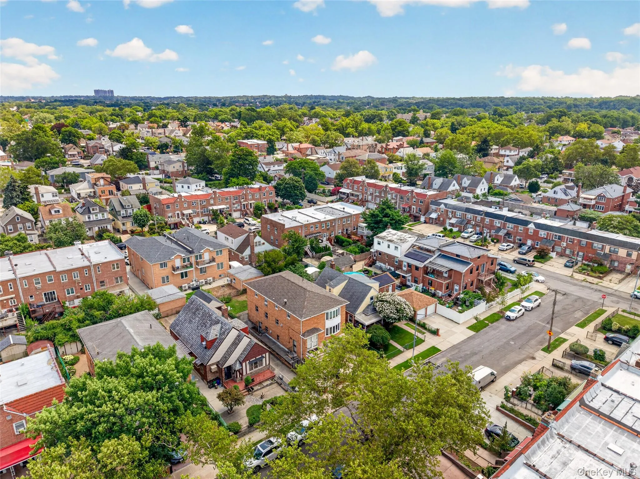 Residential neighborhood featuring a mix of multi-story brick buildings and single-family residences Residential neighborhood featuring a mix of multi-story brick buildings and single-family residences