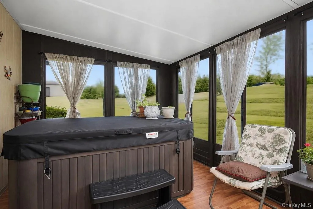 Hot tub and lots of natural light in the sun room. Hot tub and lots of natural light in the sun room.