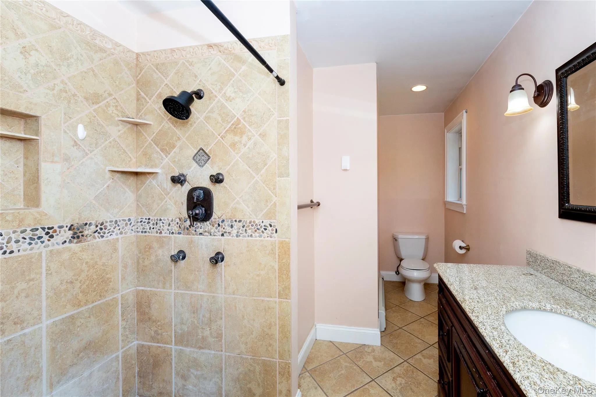 Ensuite primary bathroom with walk-in shower. Ensuite primary bathroom with walk-in shower.