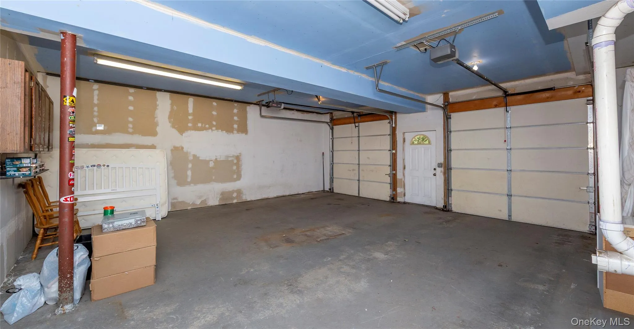 Deep two-car garage with high ceilings and a convenient exterior door leading to the driveway. Deep two-car garage with high ceilings and a convenient exterior door leading to the driveway.