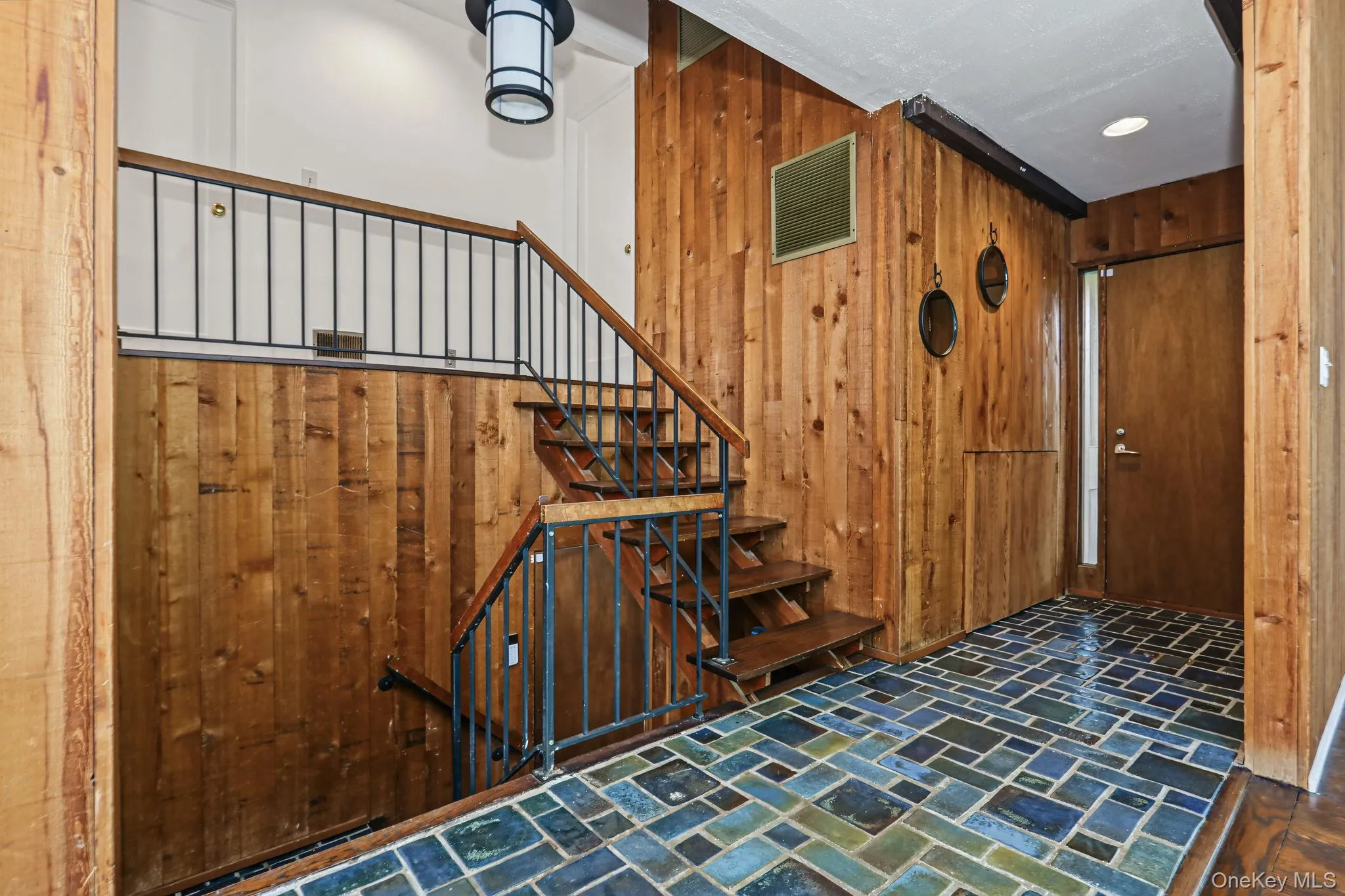 Entry with stairs going to second floor. Entry with stairs going to second floor.