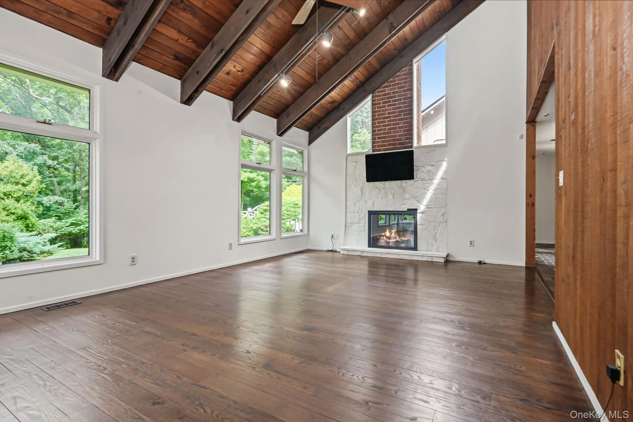 Another view of the living room with white stone fireplace. Another view of the living room with white stone fireplace.