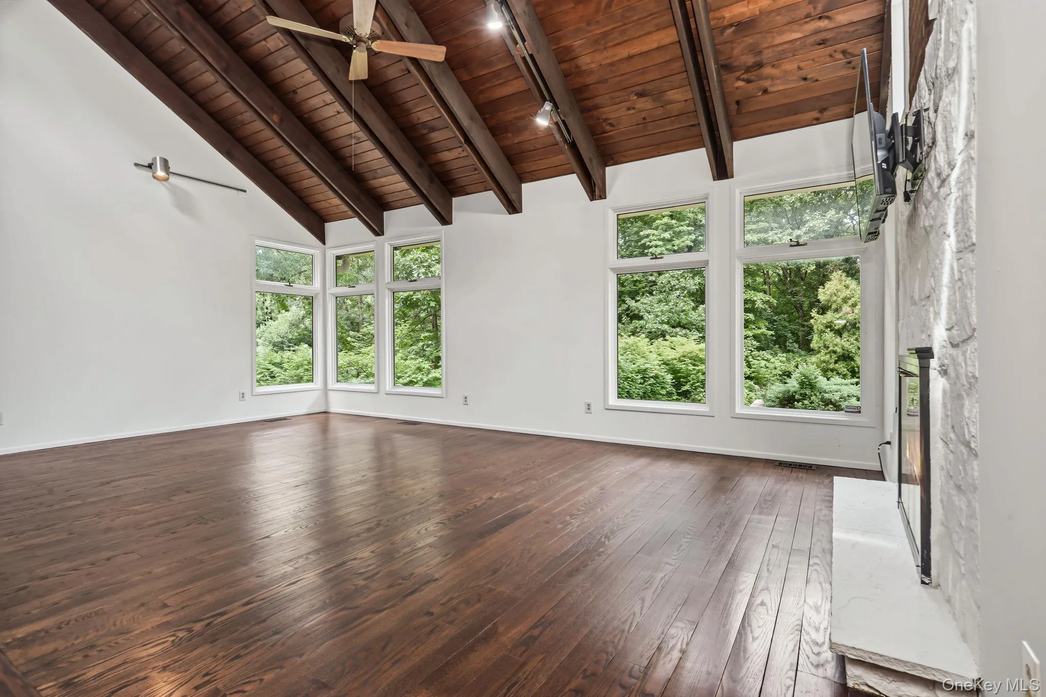 Spacious sunny living room with high beam ceiling large windows Spacious sunny living room with high beam ceiling large windows