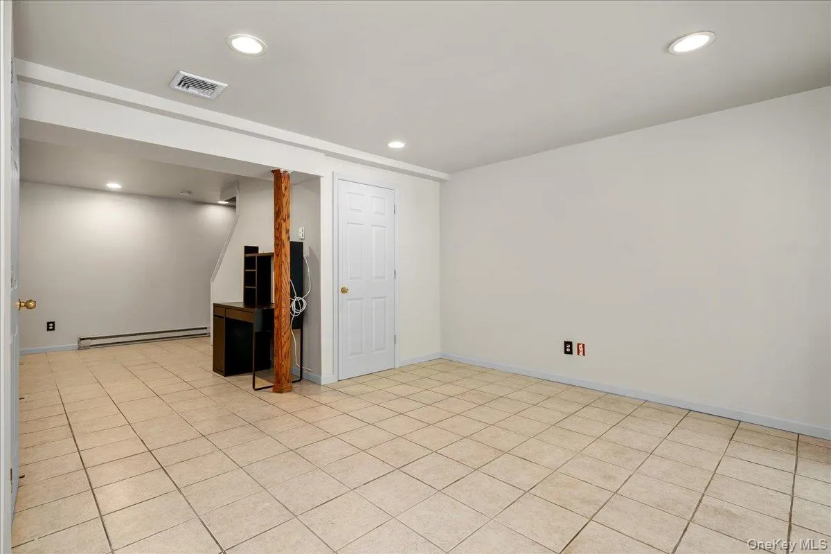 Basement with light-toned tiled flooring and recessed ceiling lighting. Sliding doors to back yard Basement with light-toned tiled flooring and recessed ceiling lighting. Sliding doors to back yard